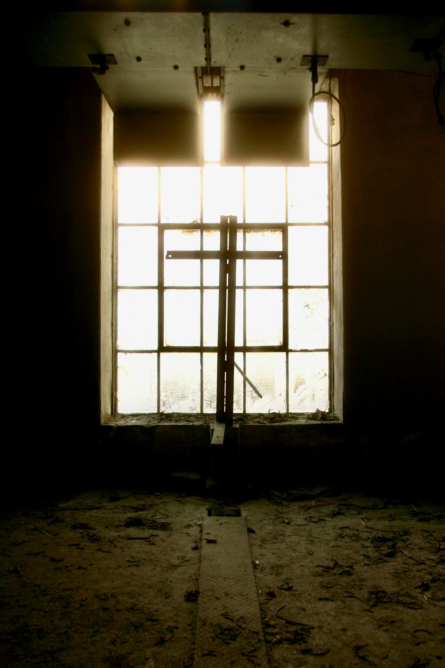 Metal structure in front of a window with dim interior