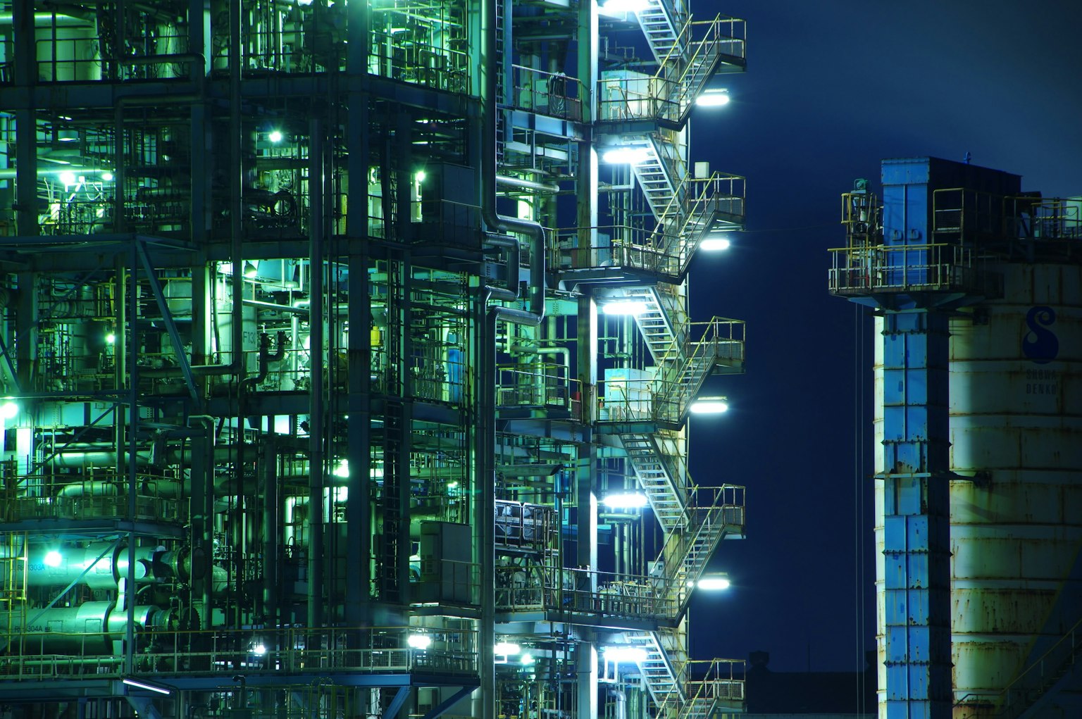Detailed structure and lighting of an industrial plant at night