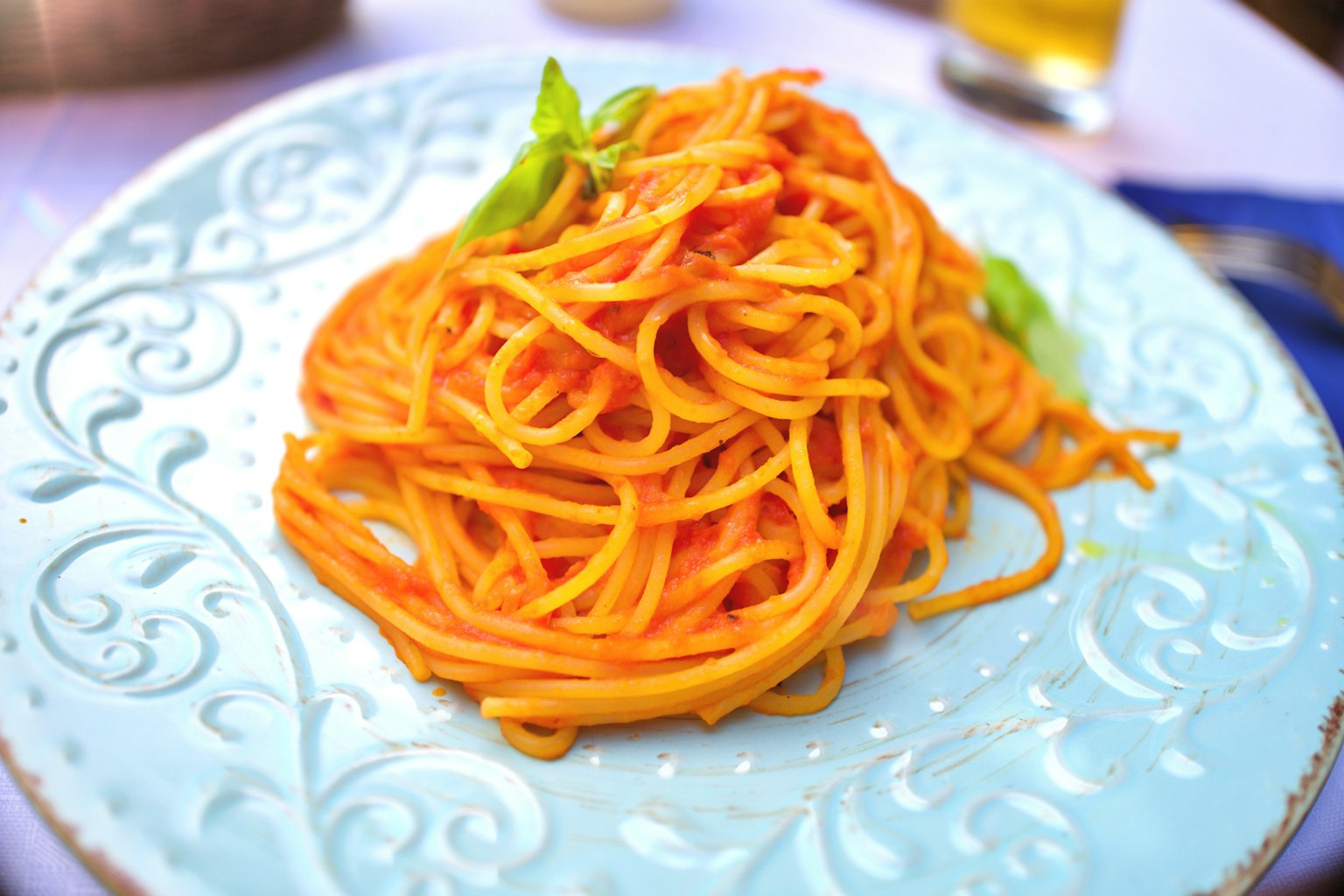 Spaghetti dish served on a blue plate