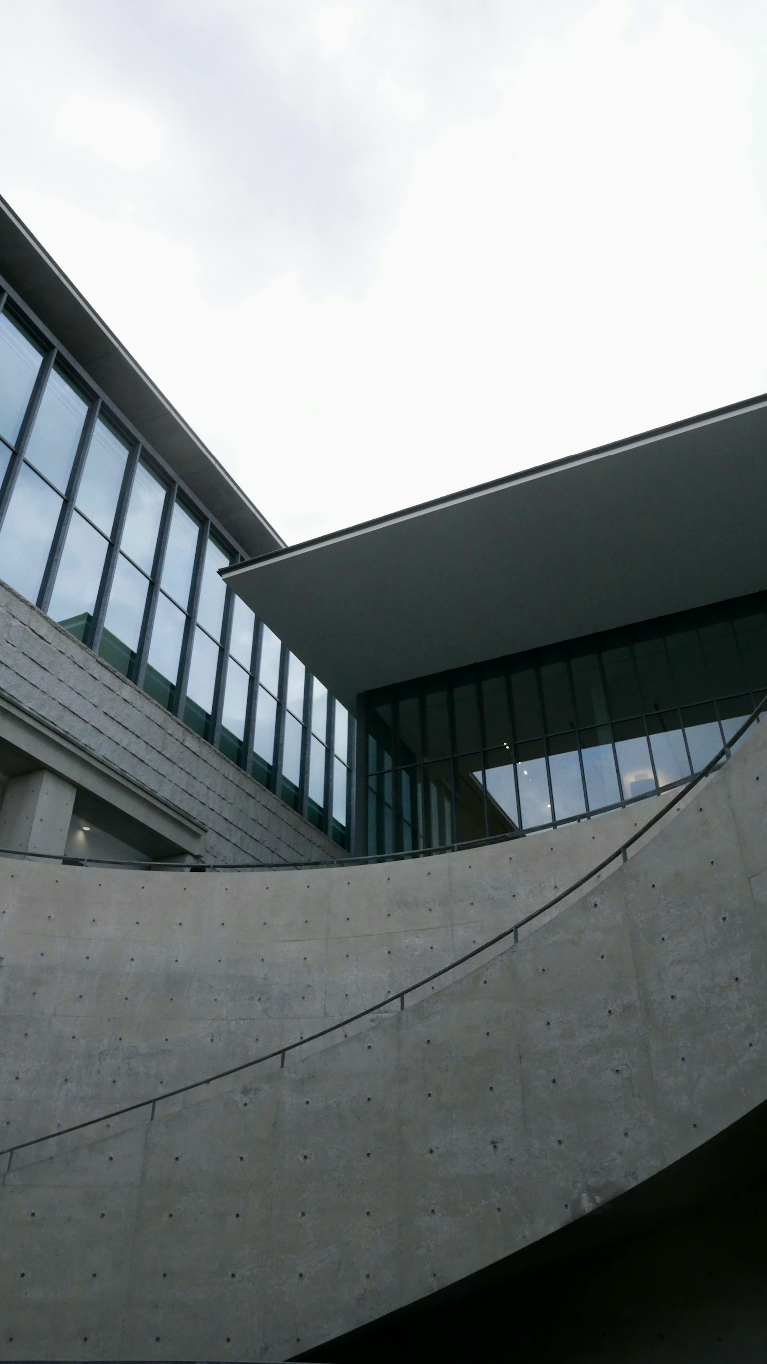 Modern architectural exterior with concrete curved staircase