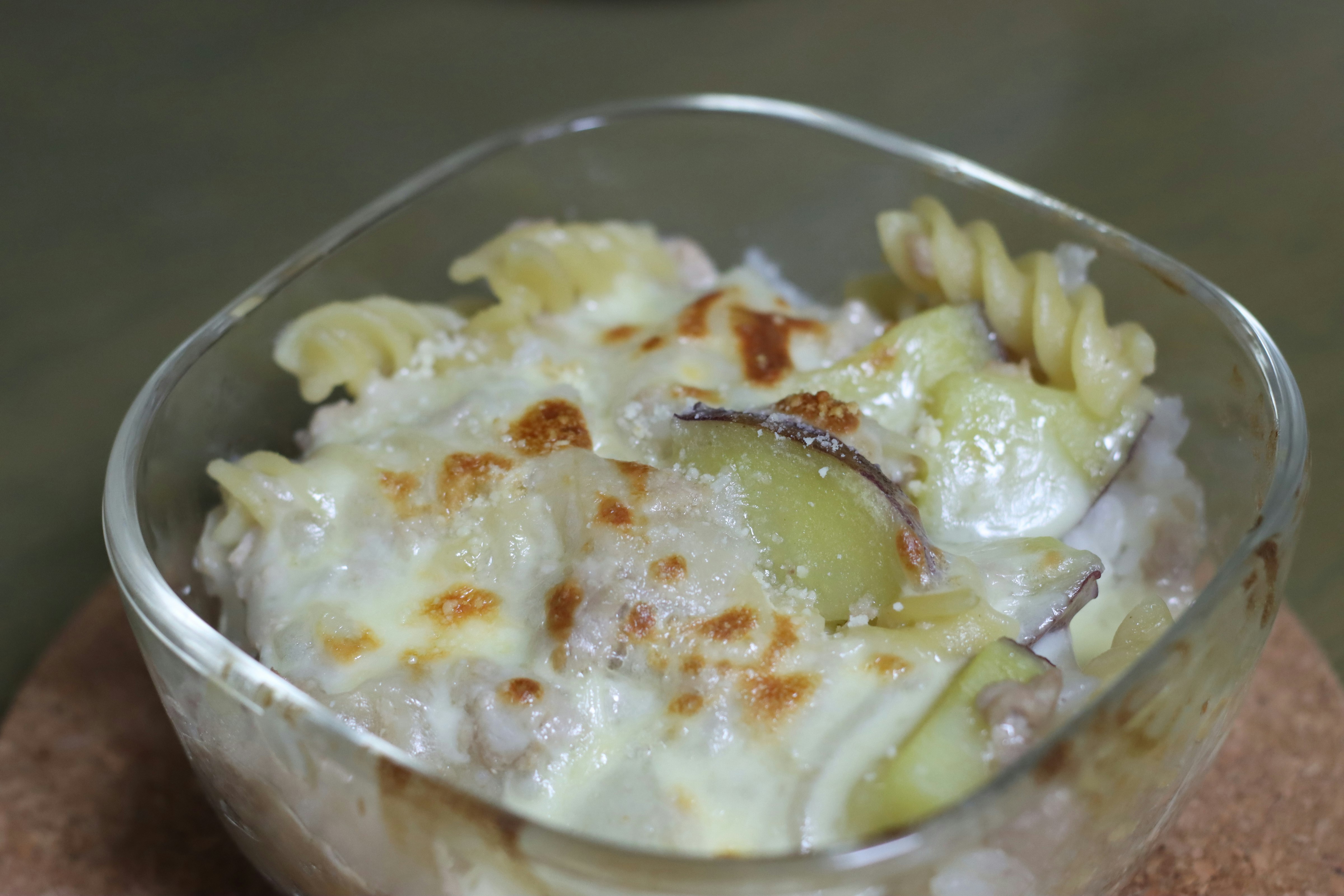 baked cheesy dish in a glass bowl
