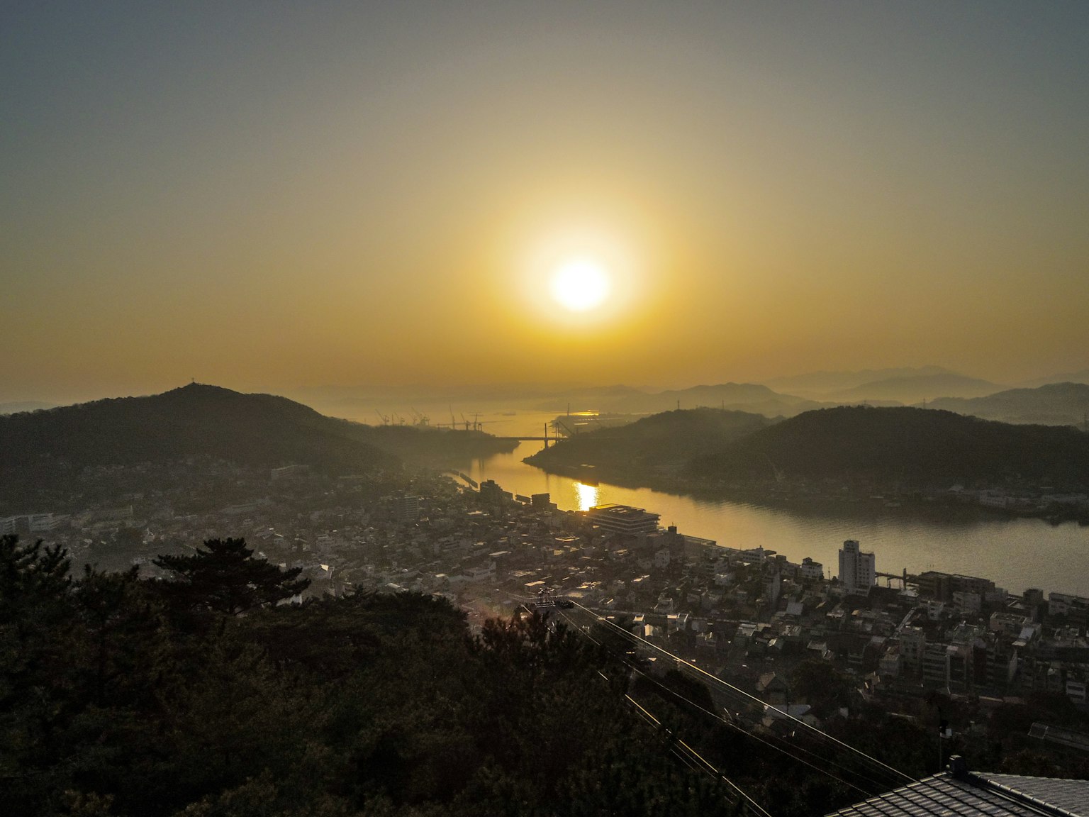Scenic view of sunset over a river and town