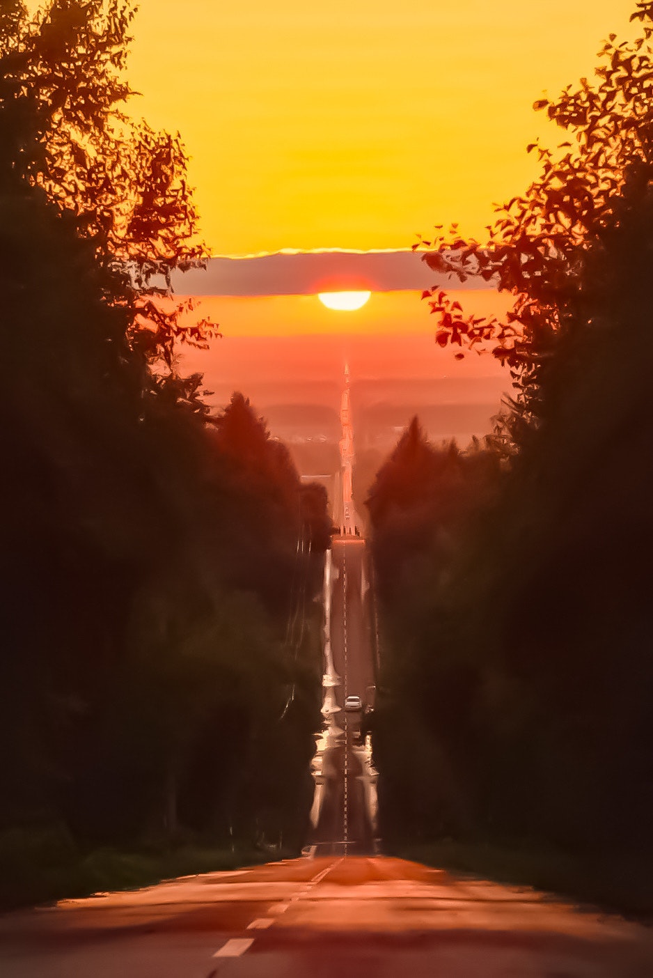 北海道斜里町の天に続く道を夕日に照らされた一本道の眺め