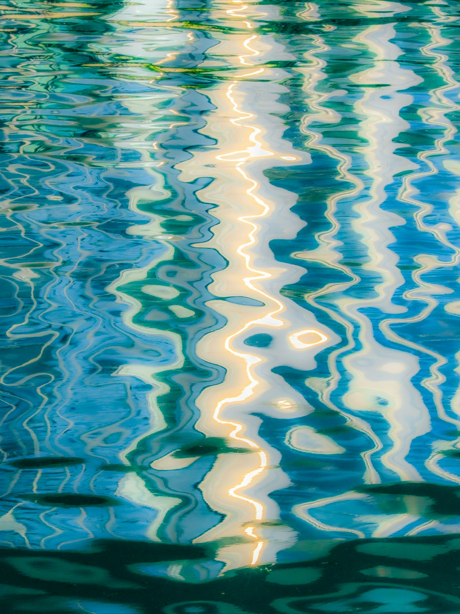 Light reflections rippling across a water surface