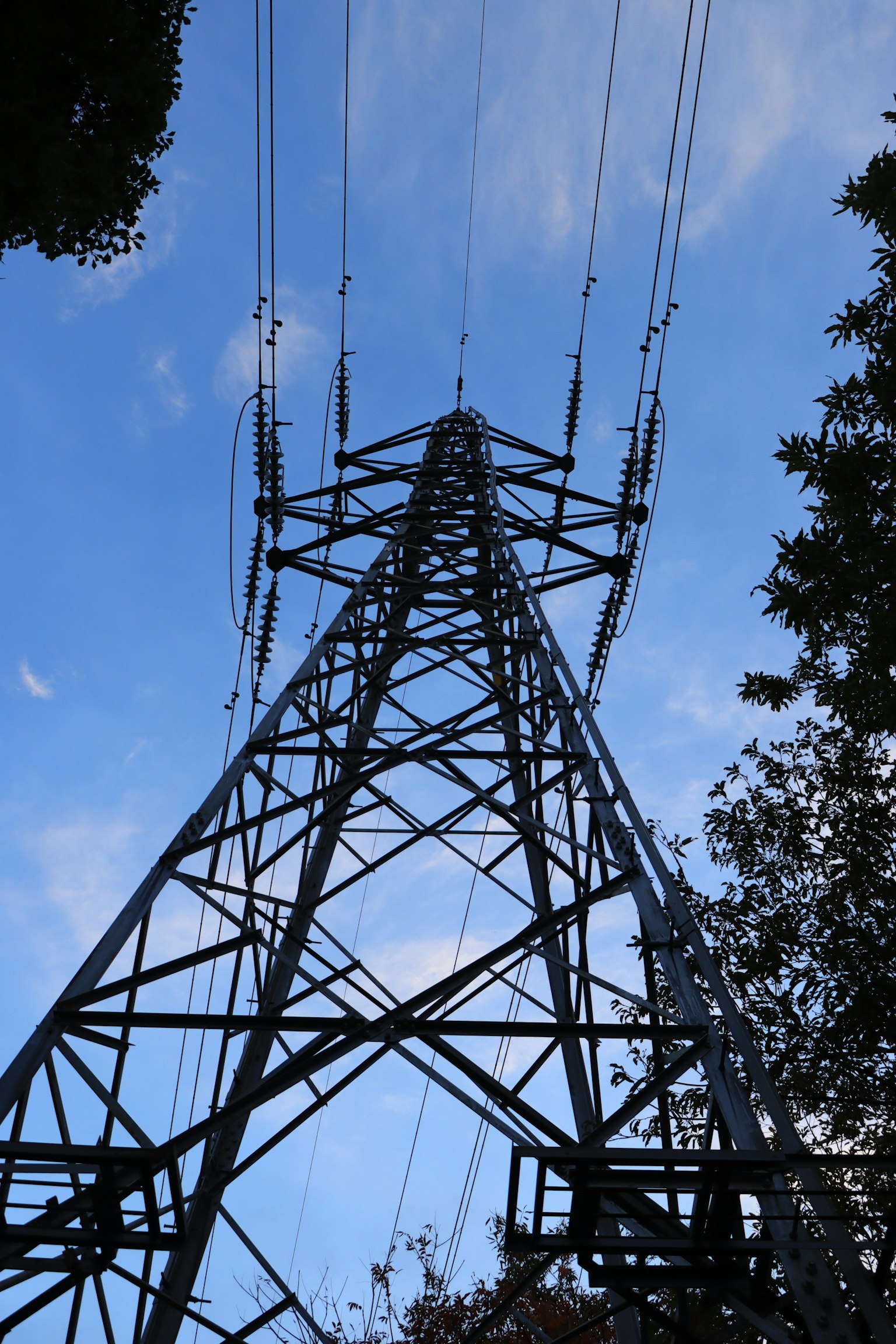 Hoher Strommast vor blauem Himmel