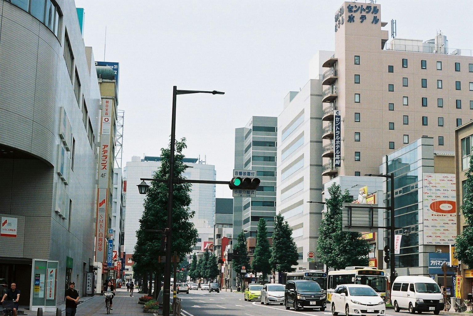 Urban street scene in Tokyo with green traffic light and buildings