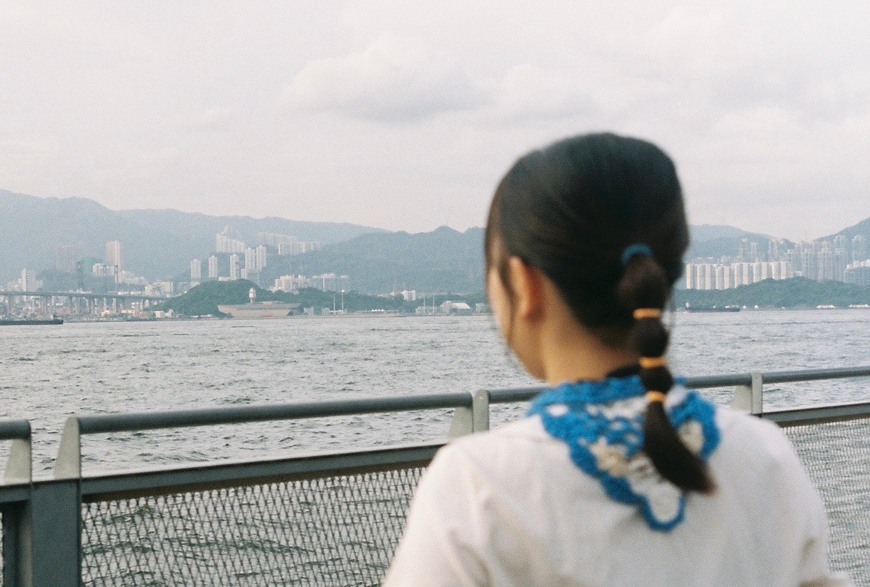 view across a bay and mountain range from a seaside promenade