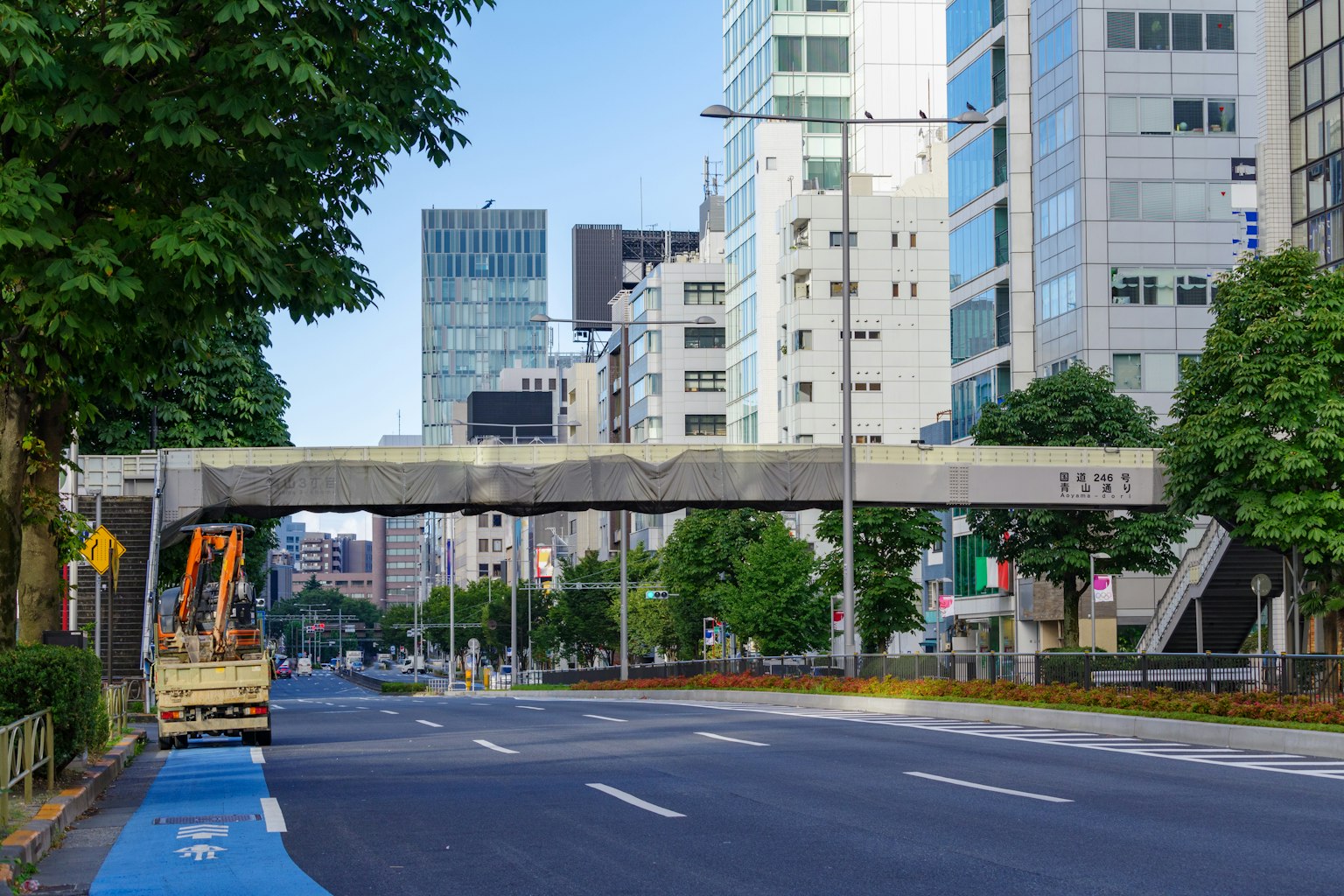 View of a street with tall buildings and an elevated road