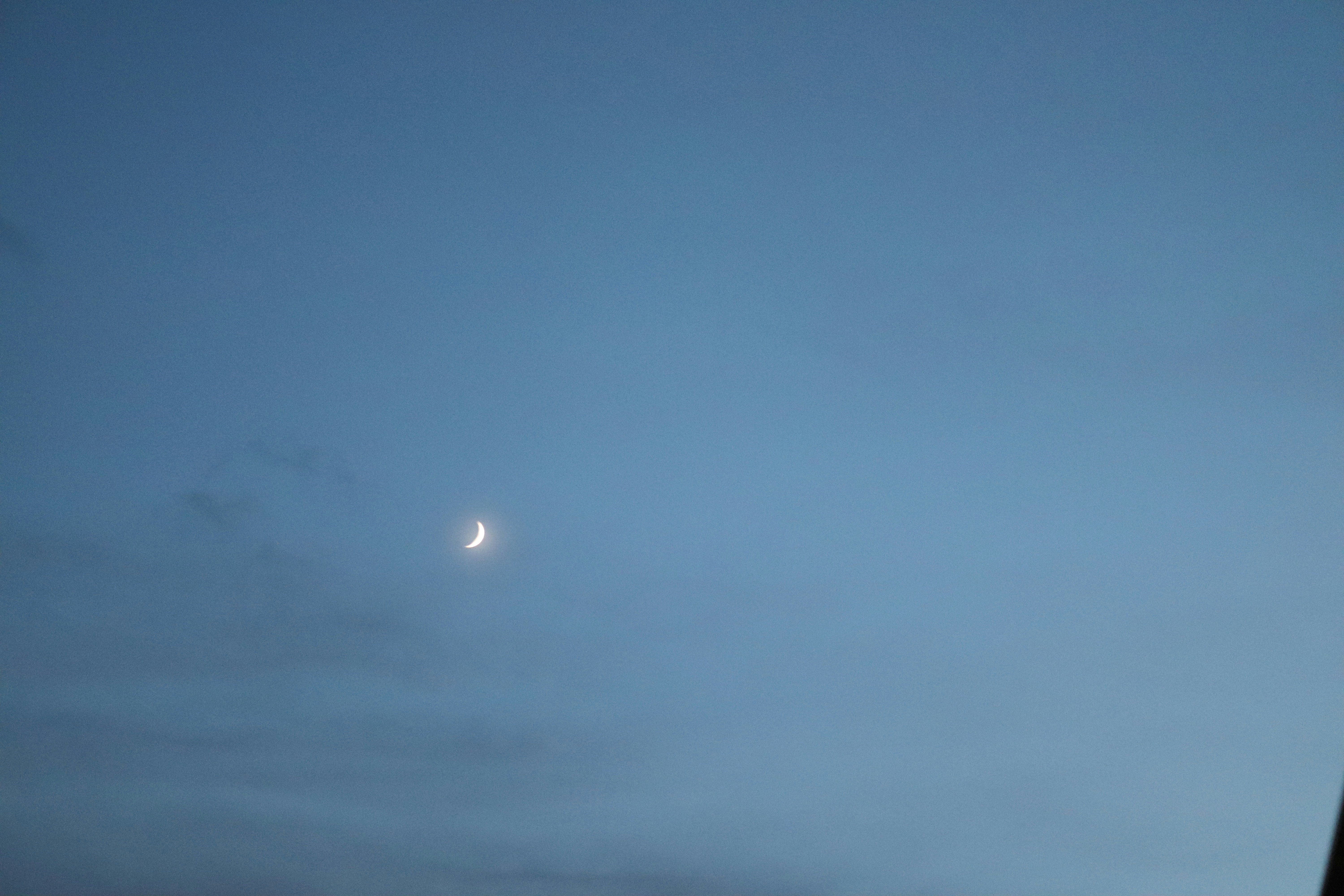 Moon and thin clouds in a blue sky