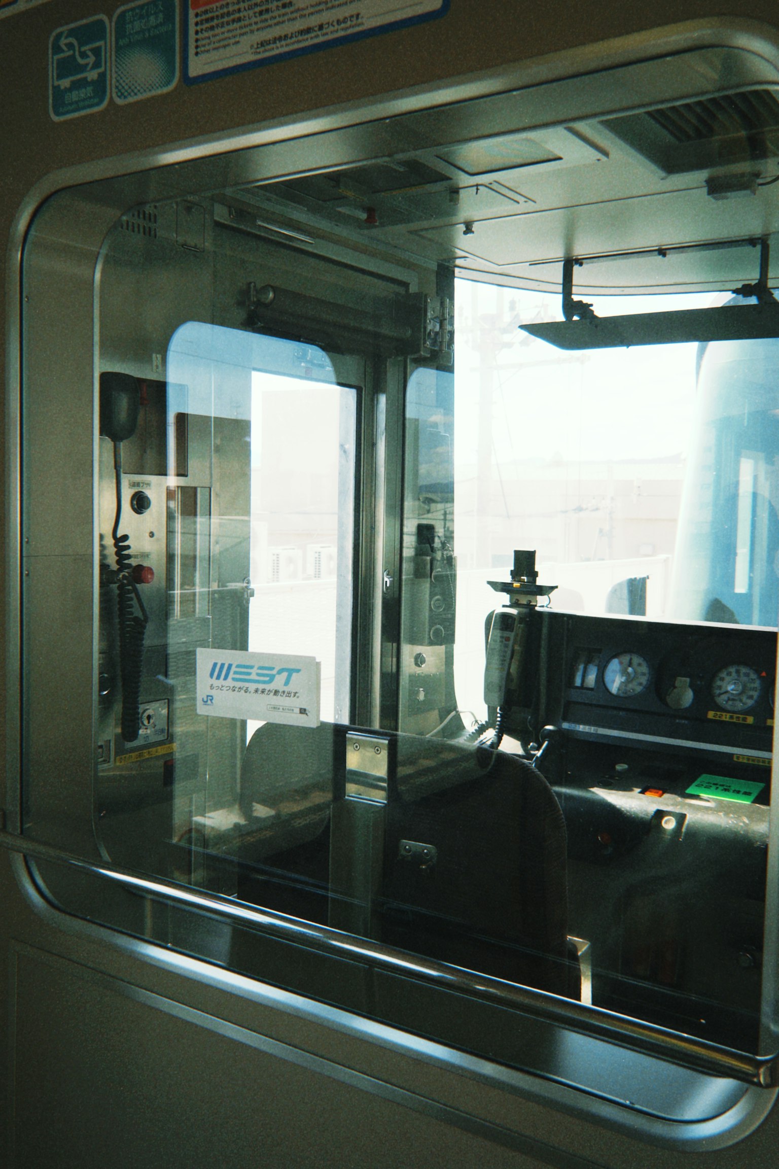 View of a train driver's cabin with control panel and instruments