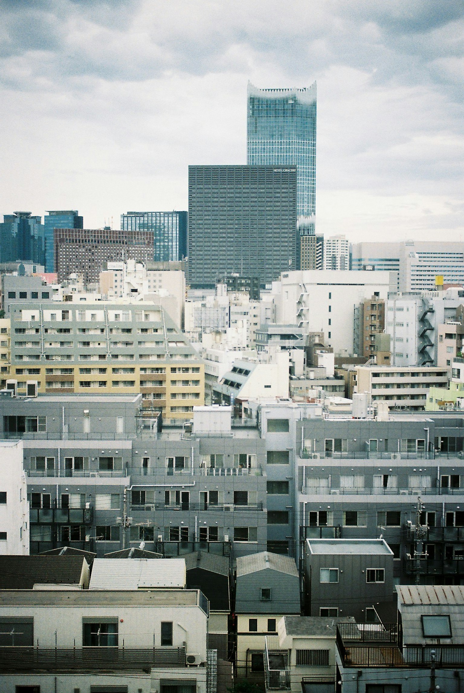 Urban landscape of Tokyo with buildings and clouds in the sky