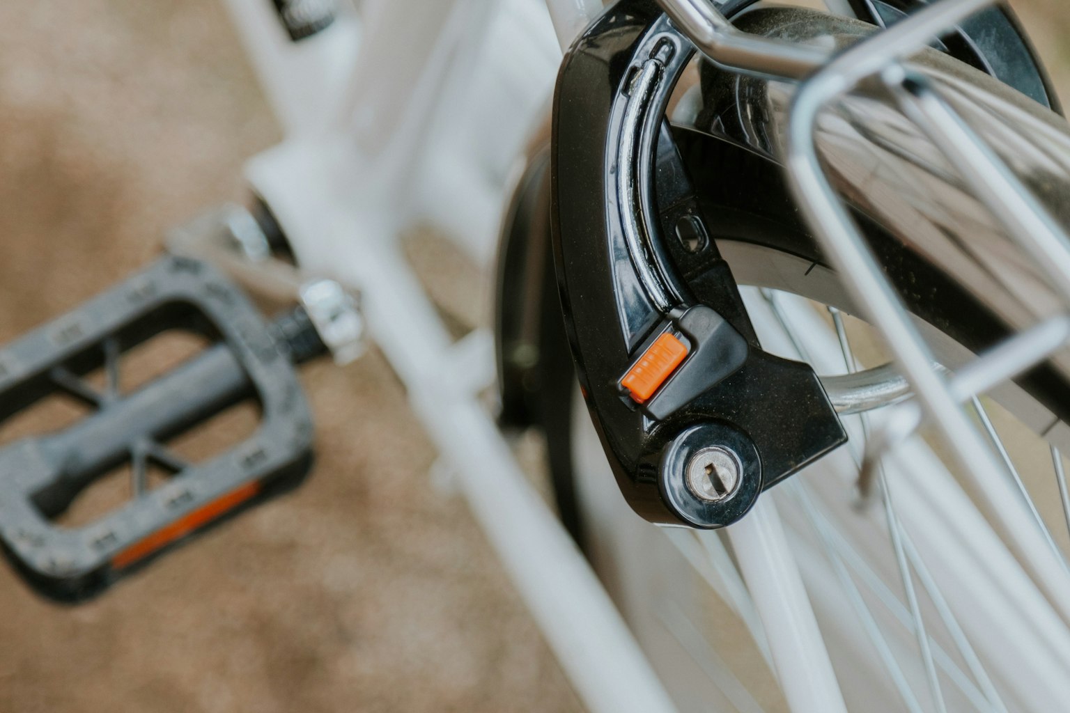 Close-up of a white bicycle pedal and locking mechanism