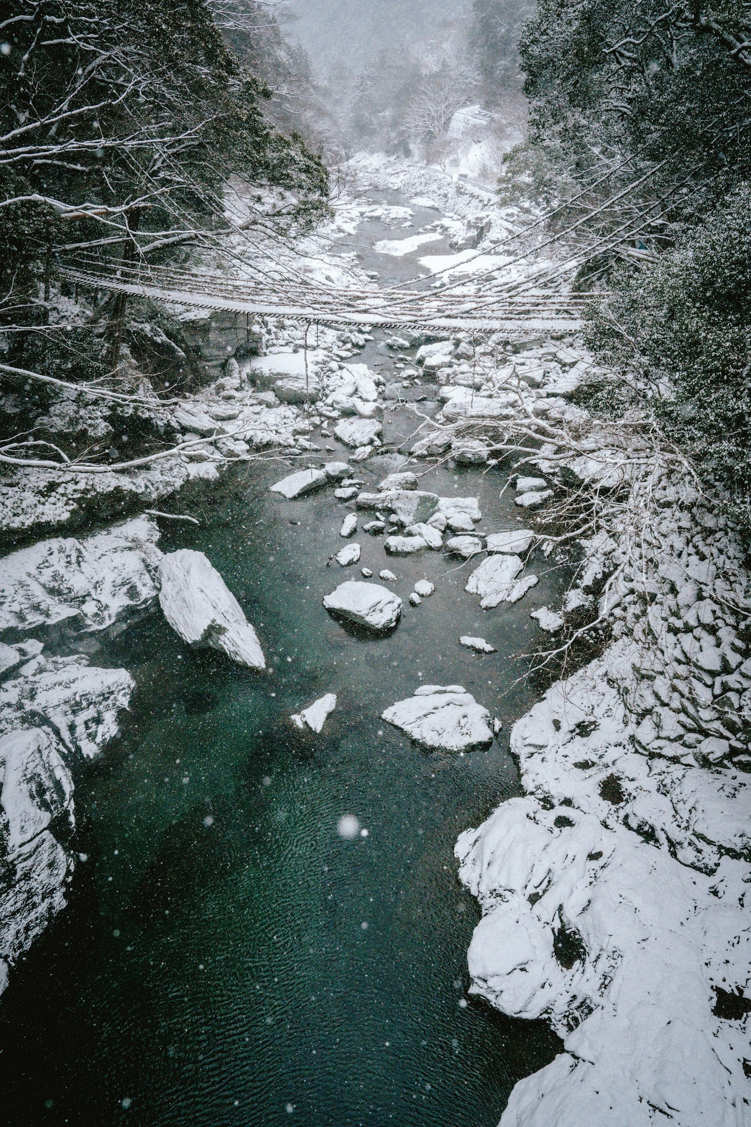 Winter landscape with a snow-covered river and rocks