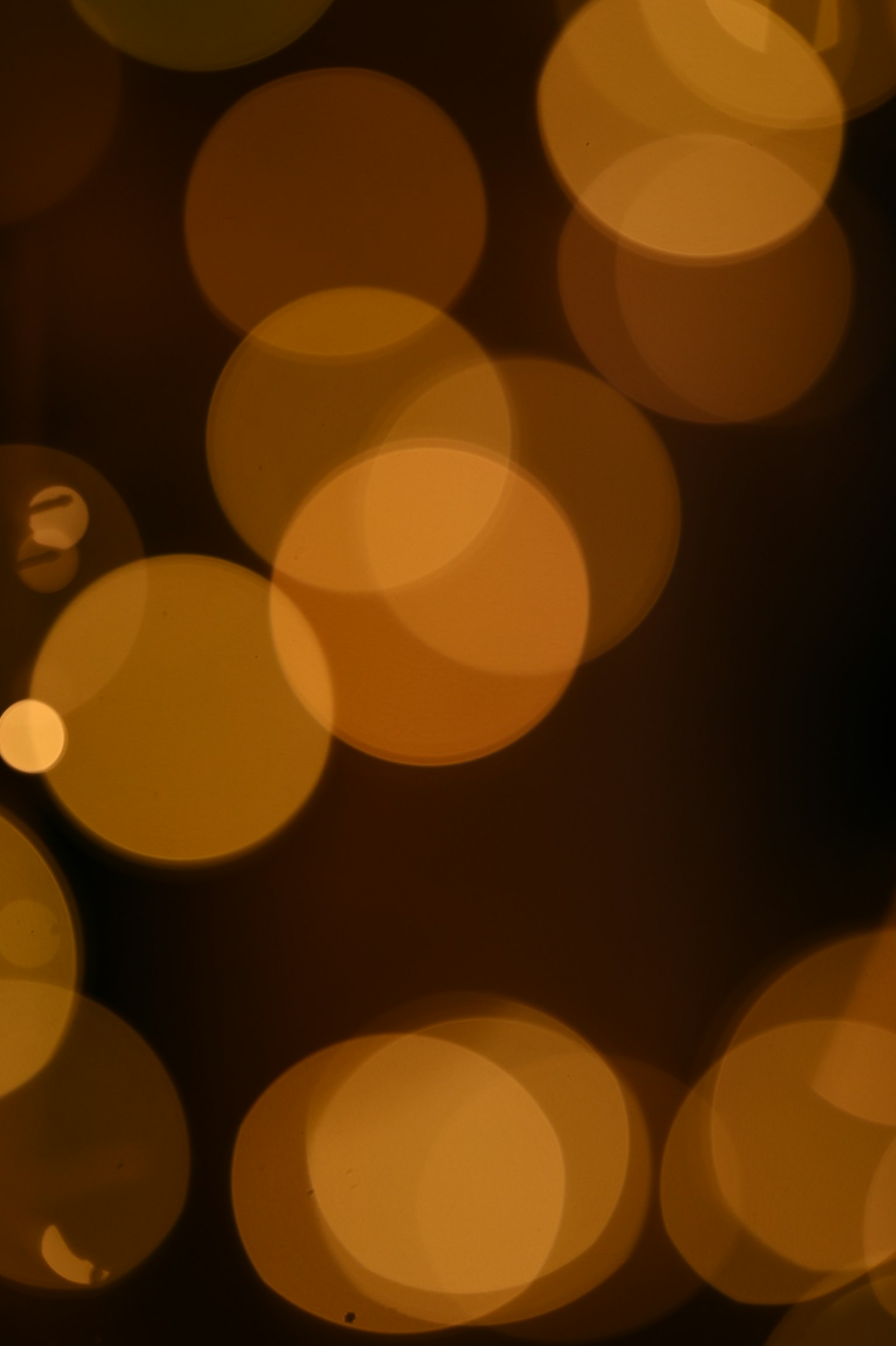 Abstract background with blurred golden light orbs