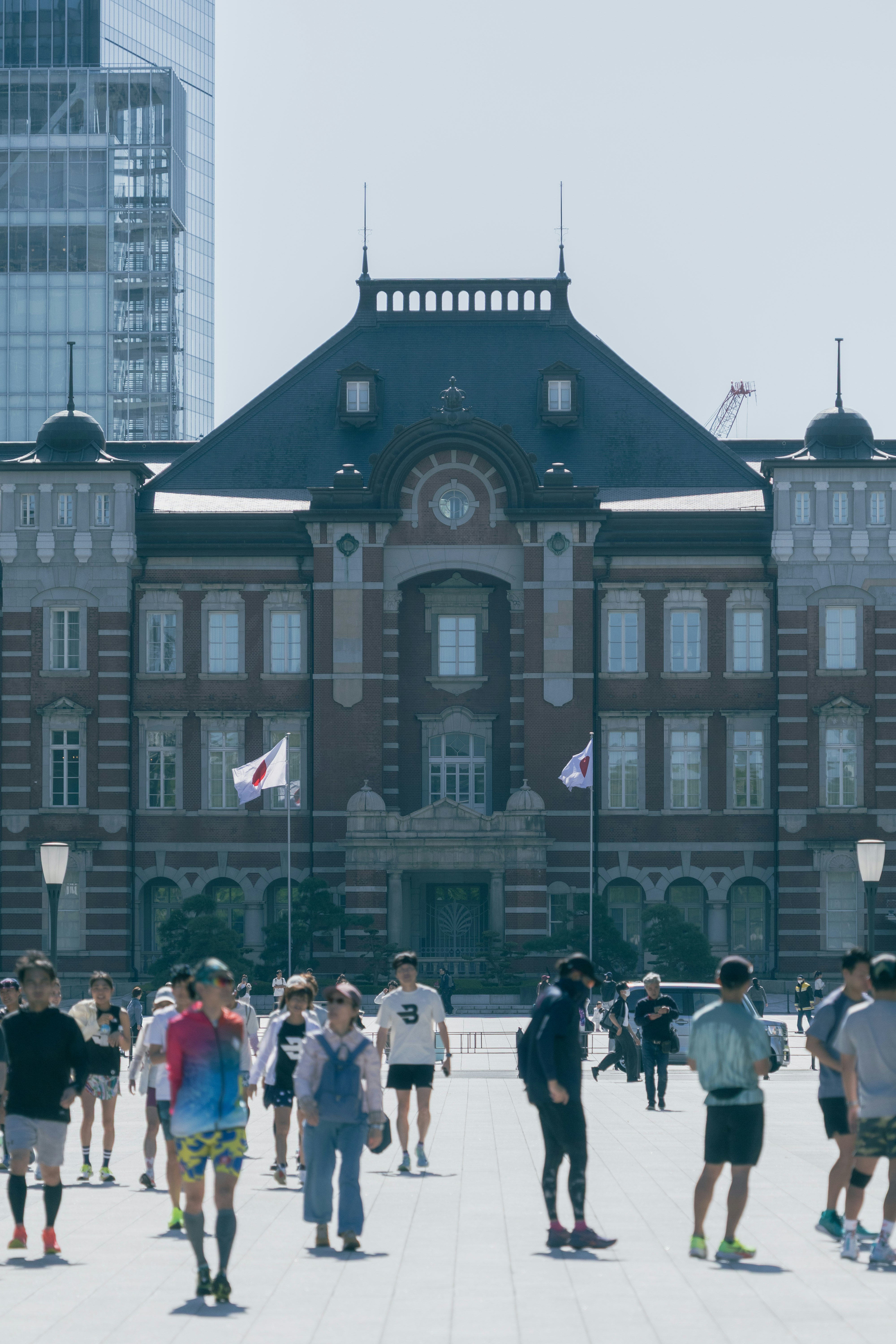 front view of Tokyo Station with people walking in the foreground