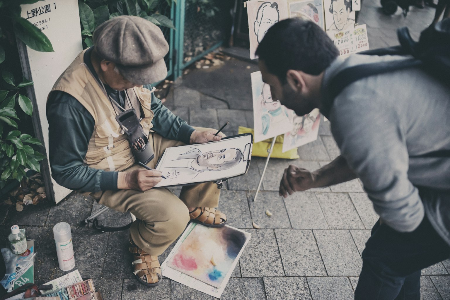 Un artista di strada che mostra la sua opera a un passante curioso