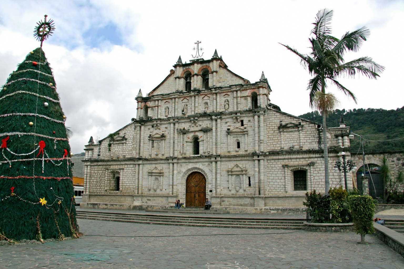 A square featuring a white church and a Christmas tree