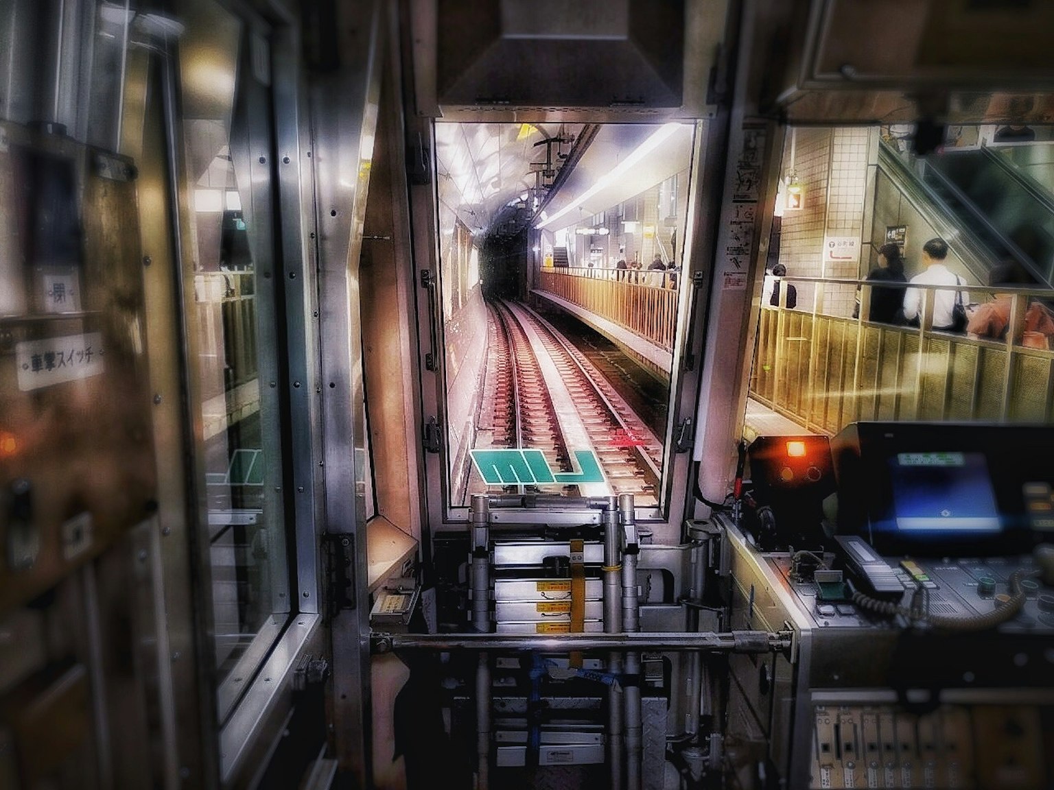 View from a train driver's cabin showing tunnel entrance and tracks