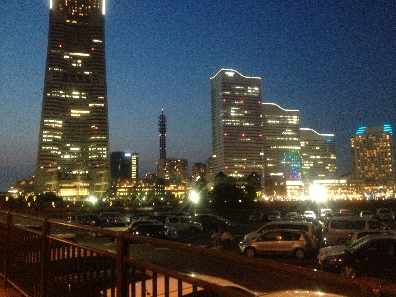 Yokohama night view featuring tall buildings and parked cars