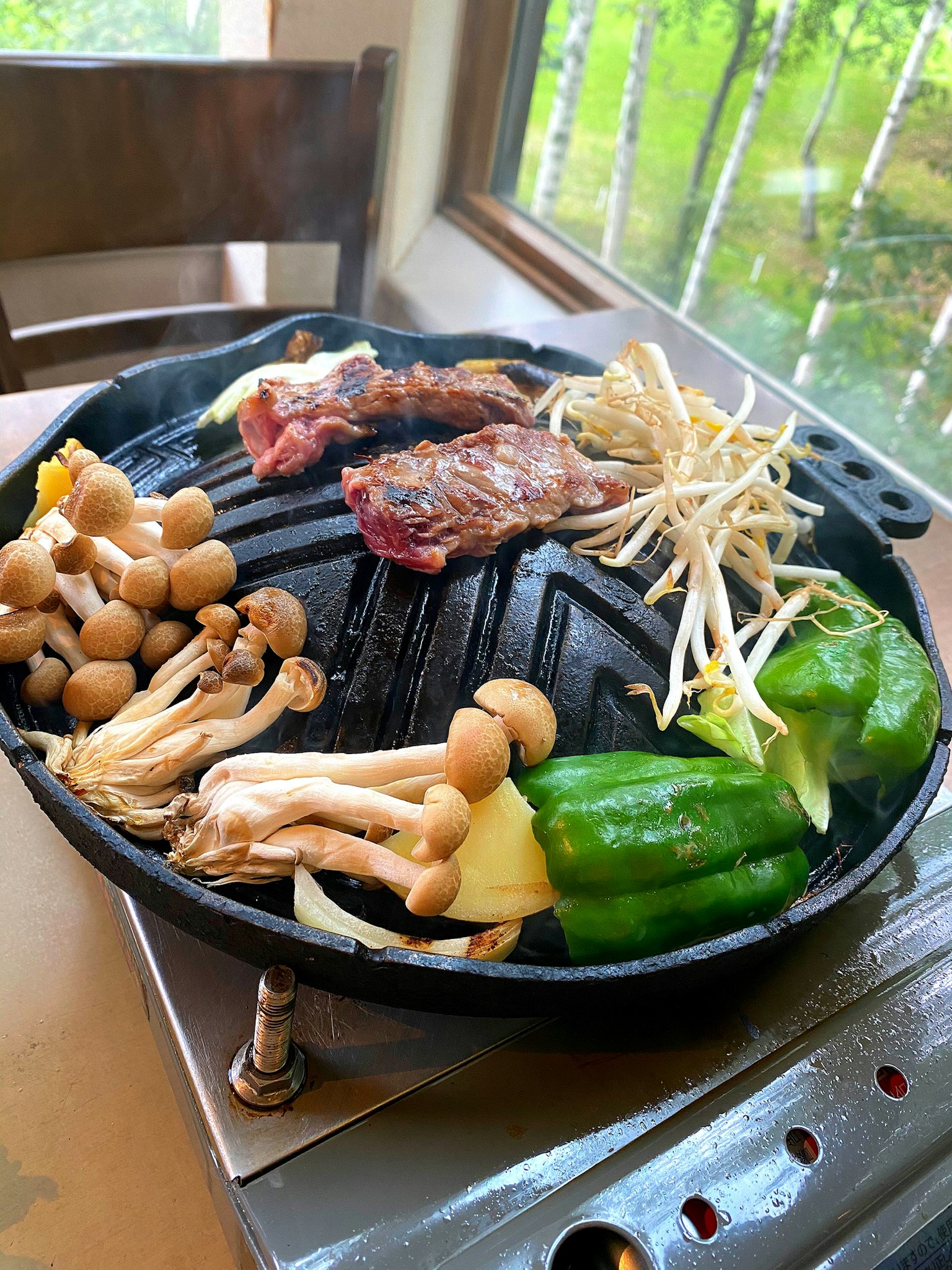 Grill with assorted meats and vegetables on a table