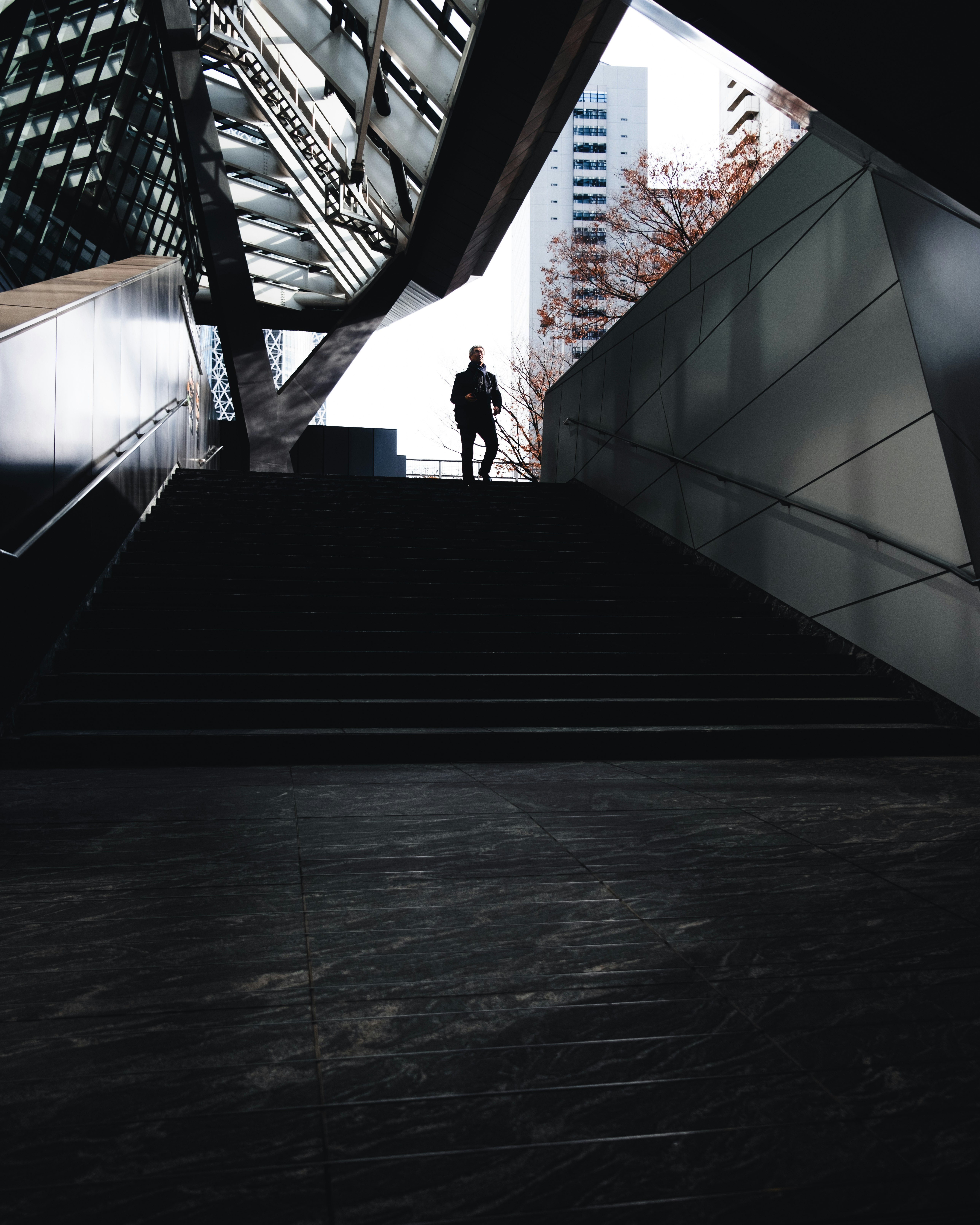 silhouette of a person standing in a stairwell atrium