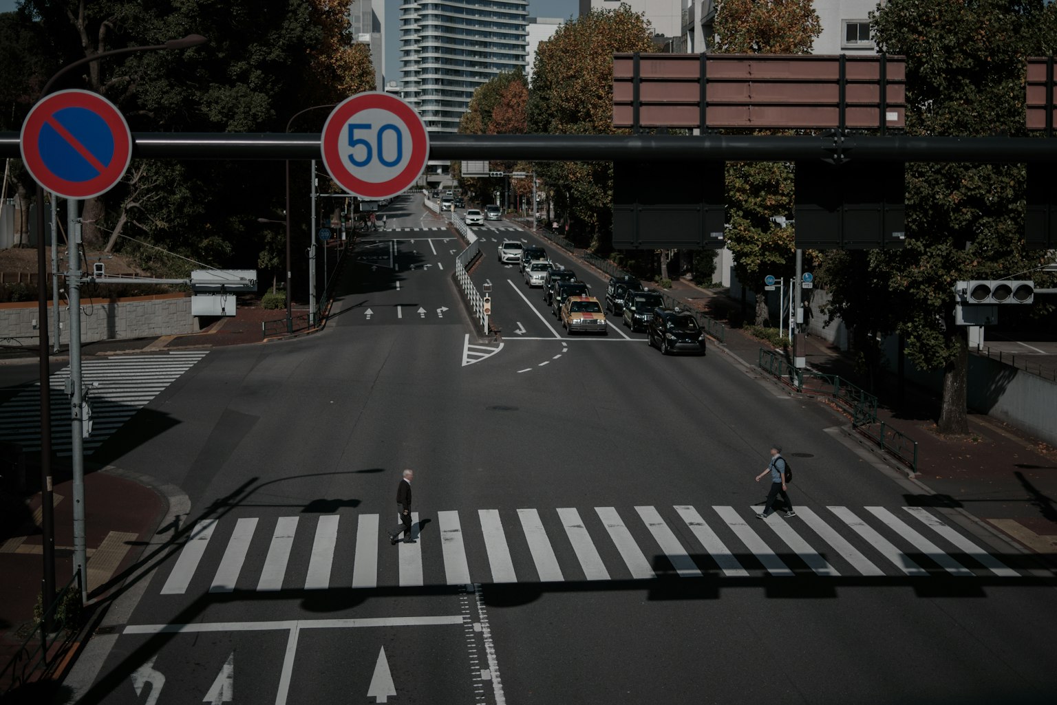 Urban intersection featuring a crosswalk and traffic signs