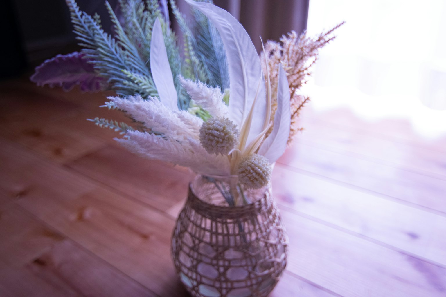 A basket with soft-colored dried flowers arranged artistically