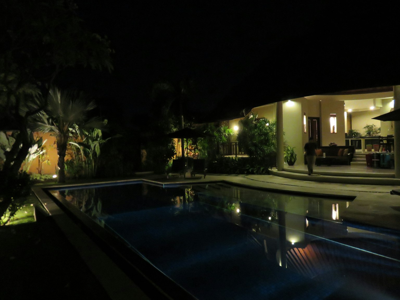 Beautiful view of a poolside at night with illuminated house
