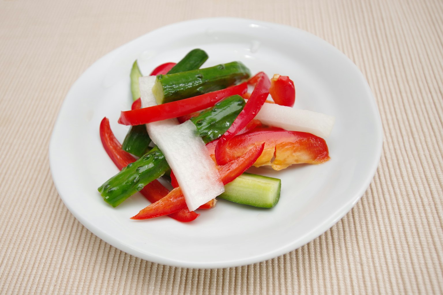Colorful vegetable salad arranged on a white plate