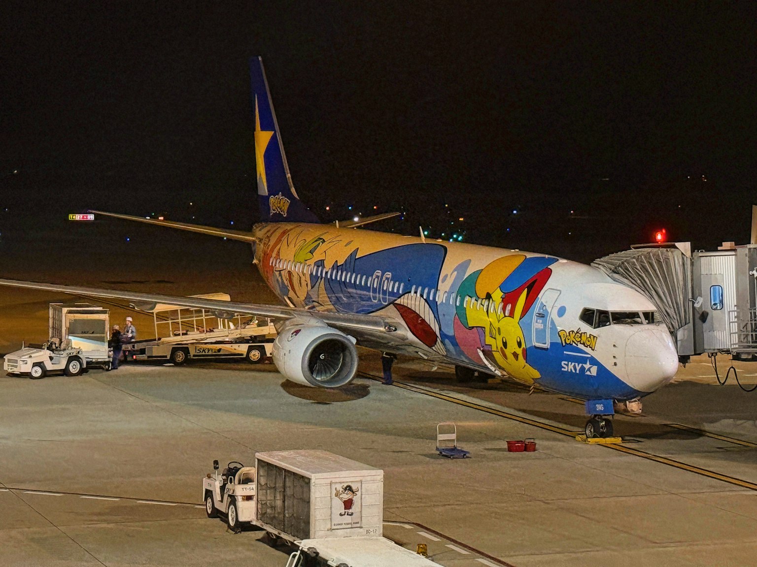 Colorful airplane parked at the airport at night