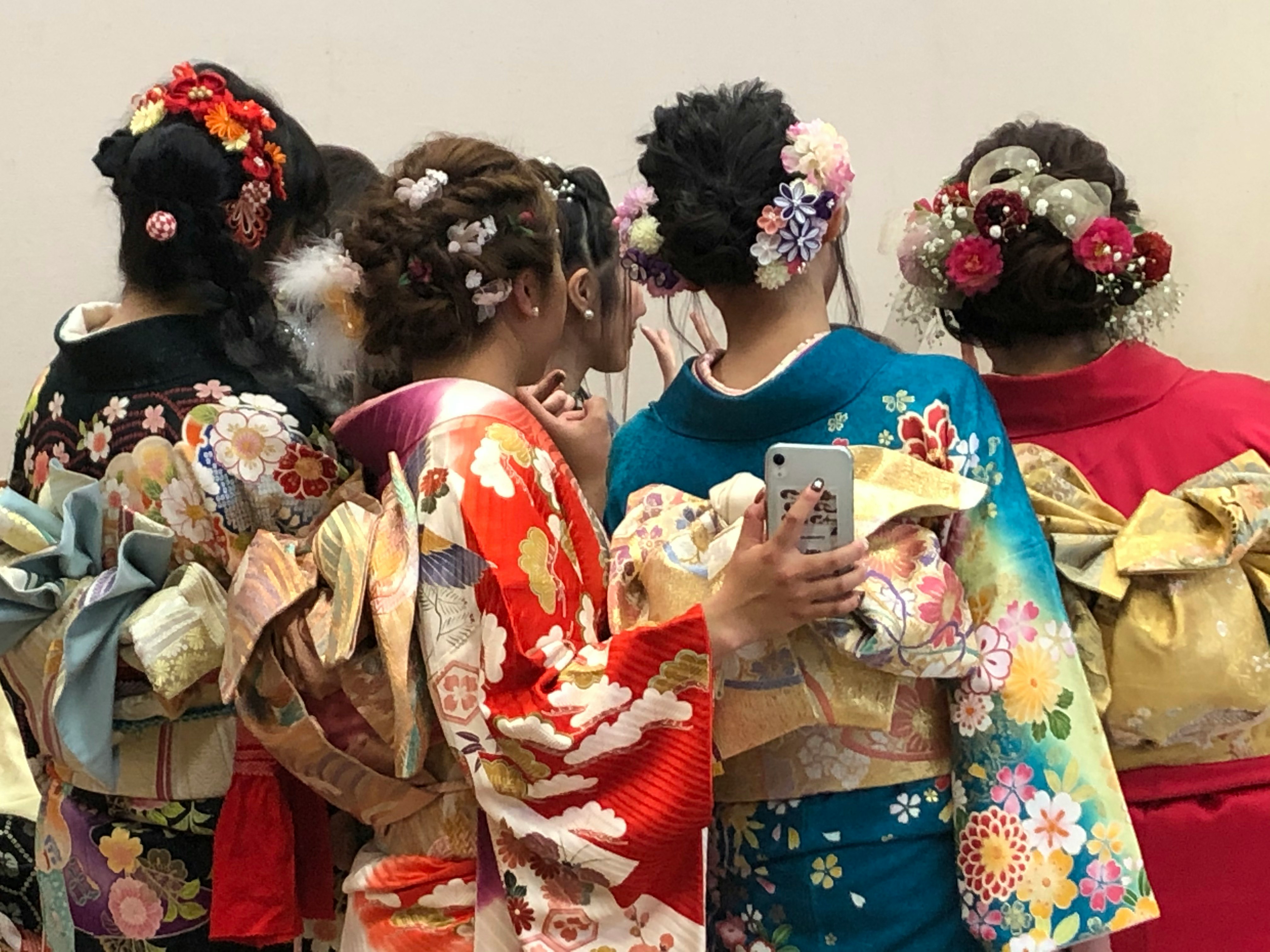 Children in colorful kimono with floral hair accessories