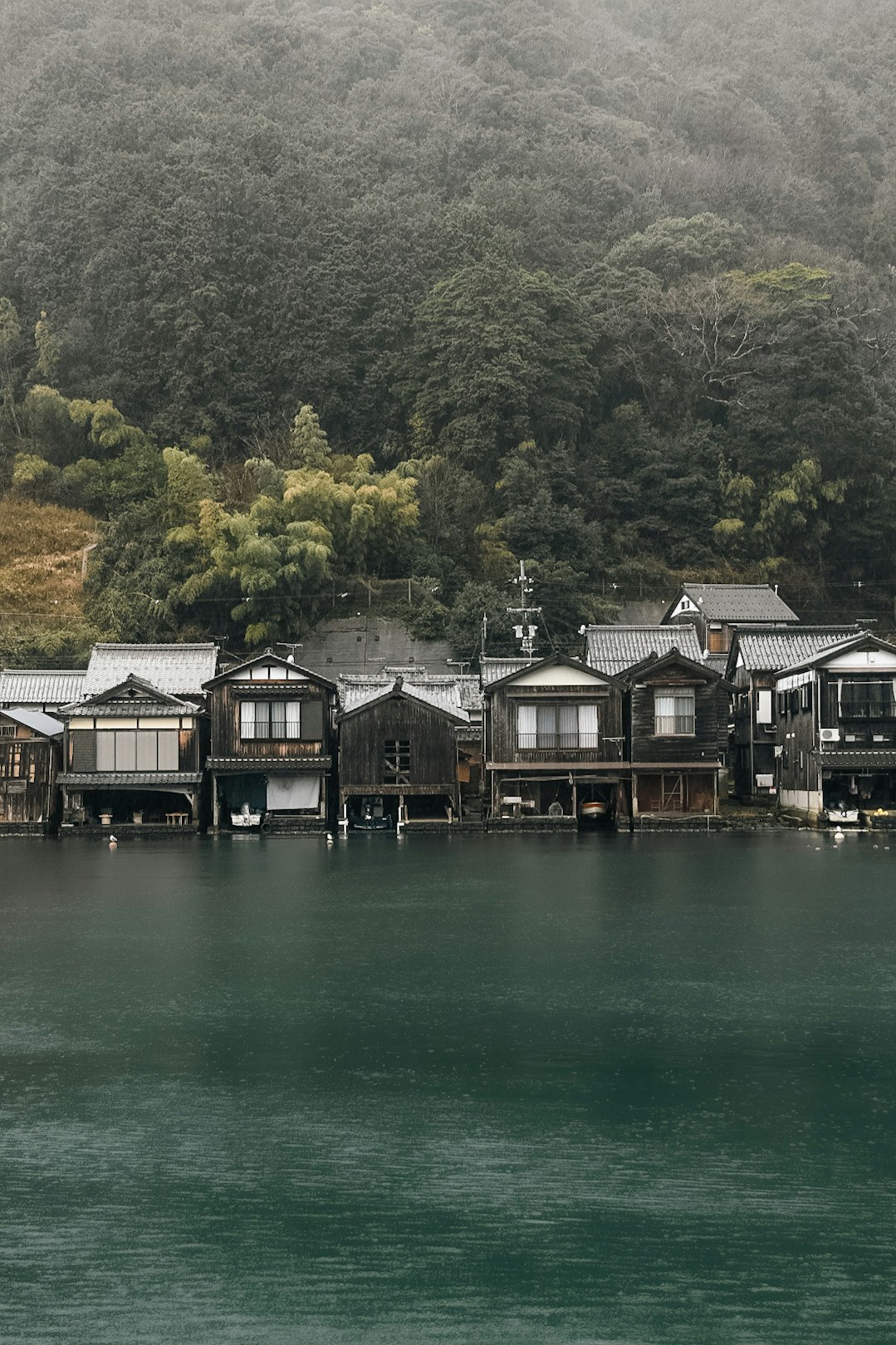 fisherman’s houses along a riverbank and calm water