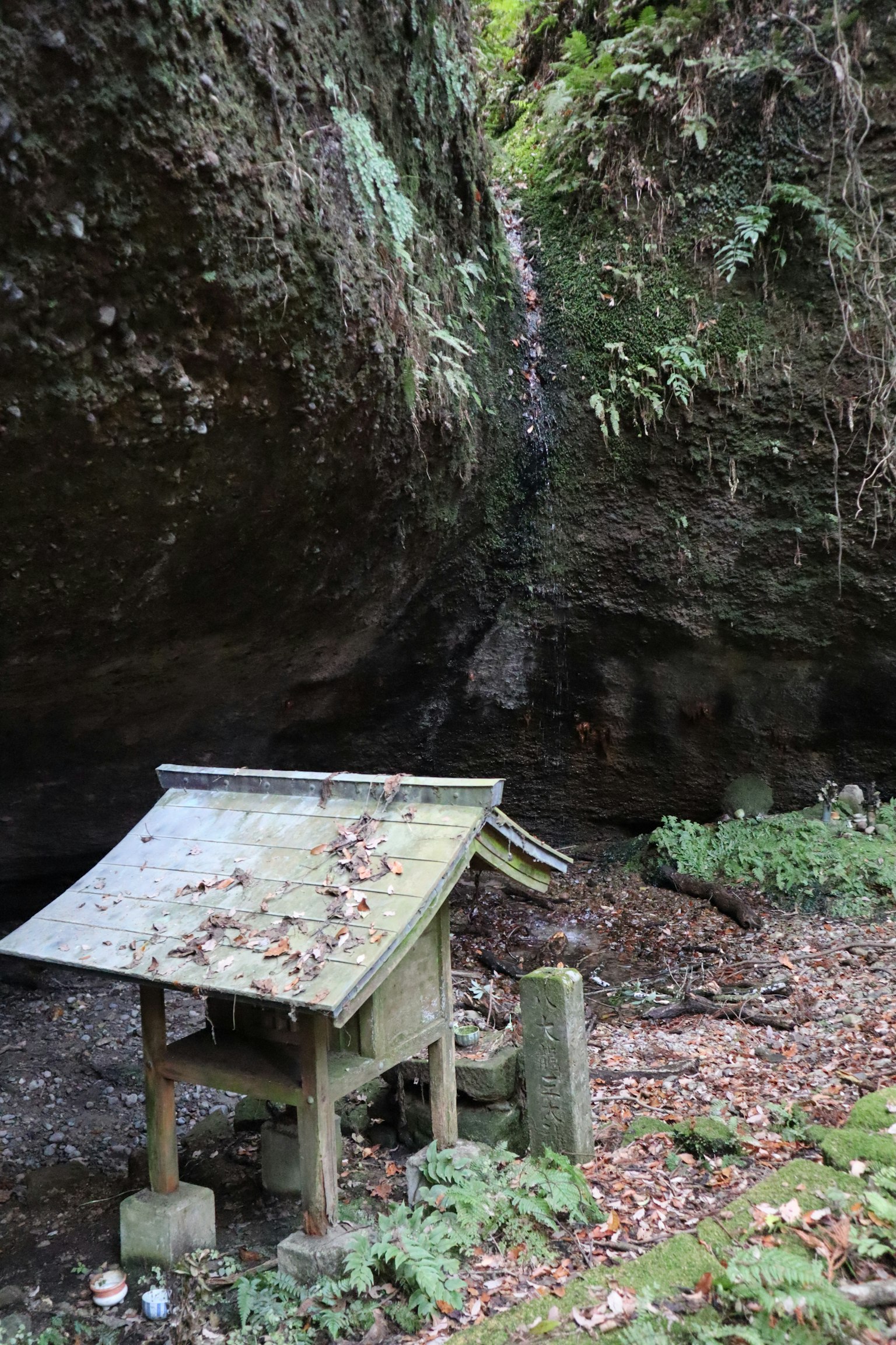 Lembah tenang dengan batu berlumut dan kuil kecil