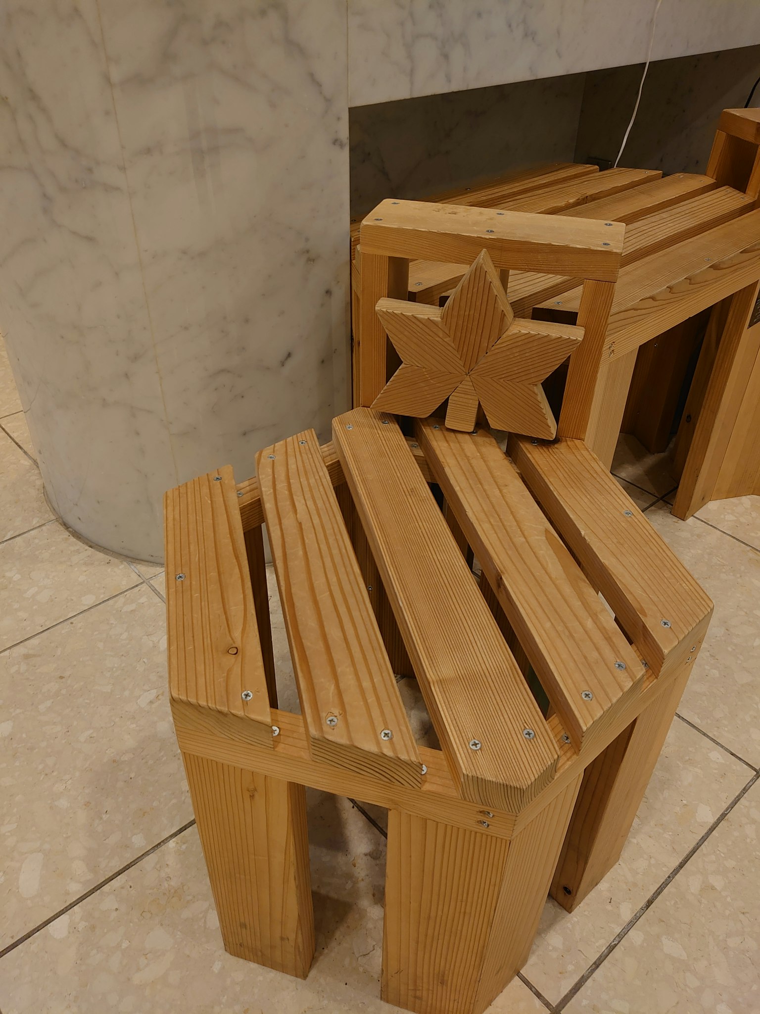 Wooden seating design featuring a hexagonal stool and a bench with a star motif