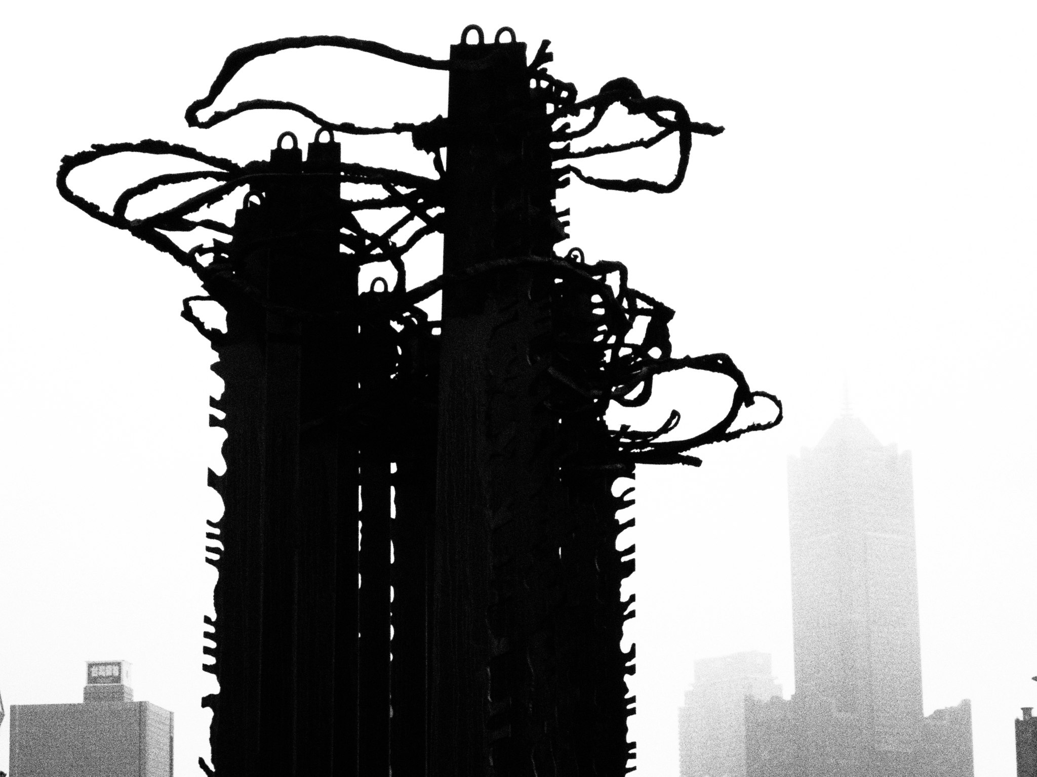 silhouette of layered black mechanical parts against a white background