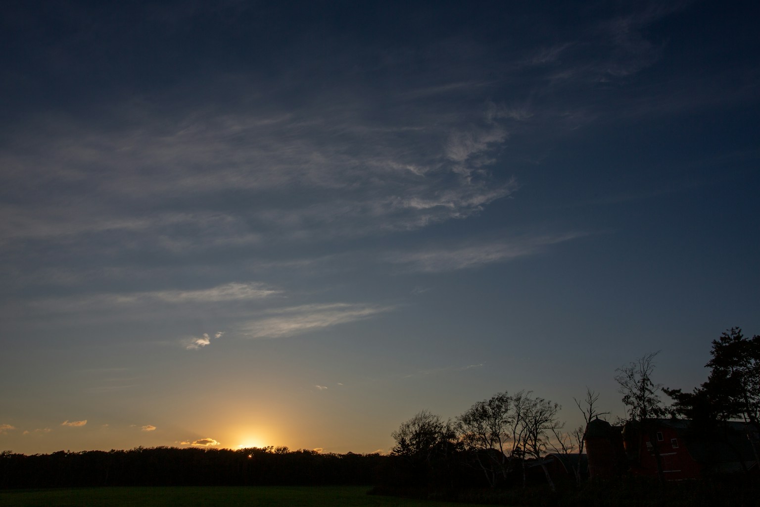Sunset landscape with blue sky and floating clouds