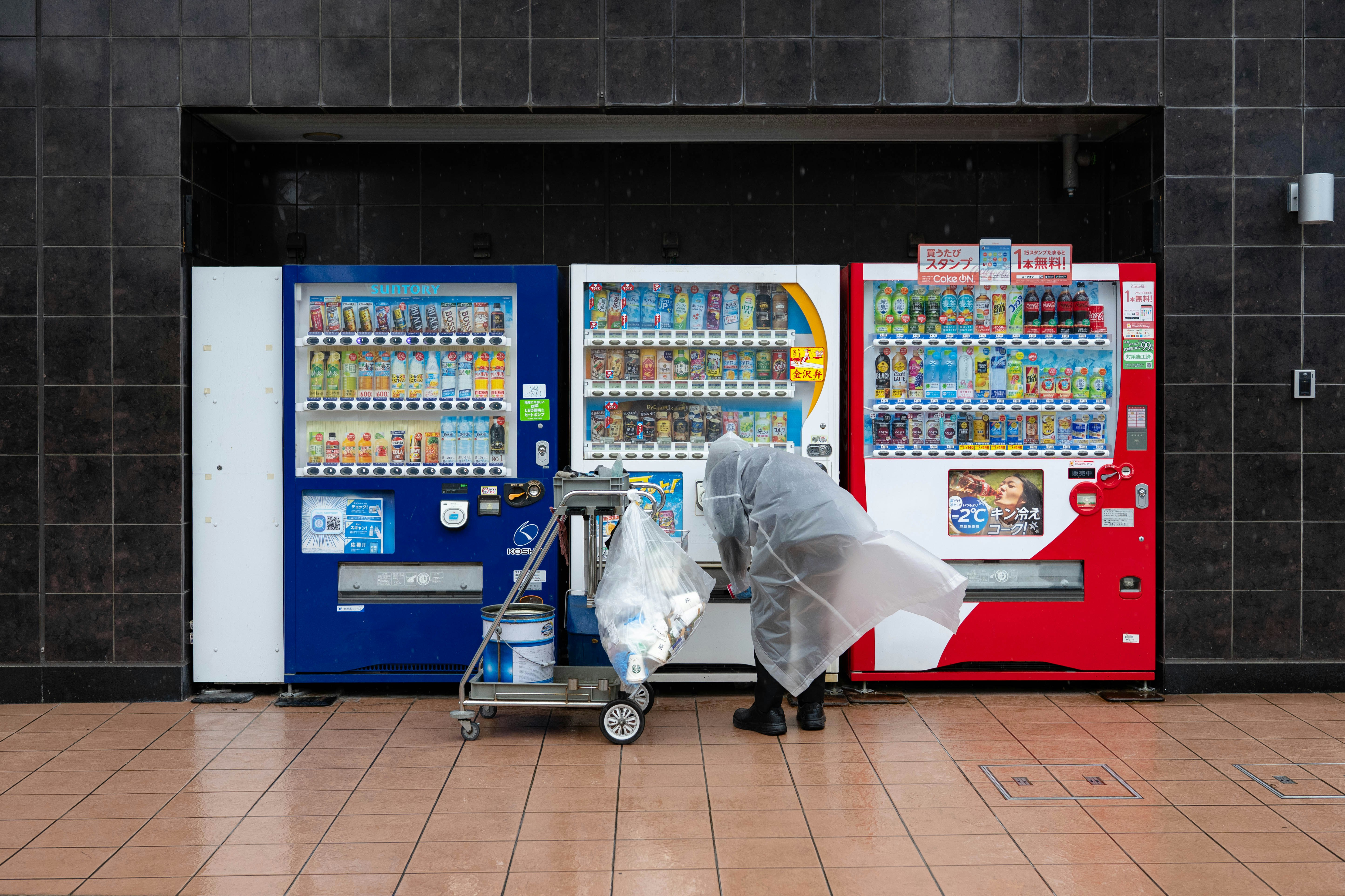cleaning worker in front of vending machines at a pharmacy