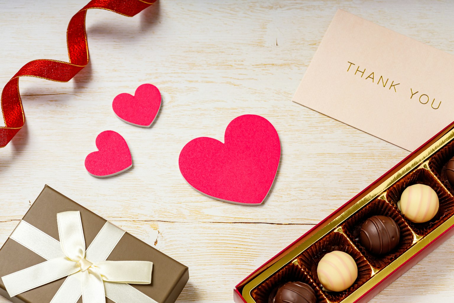 Red heart-shaped cards with chocolates for Valentine's Day decoration