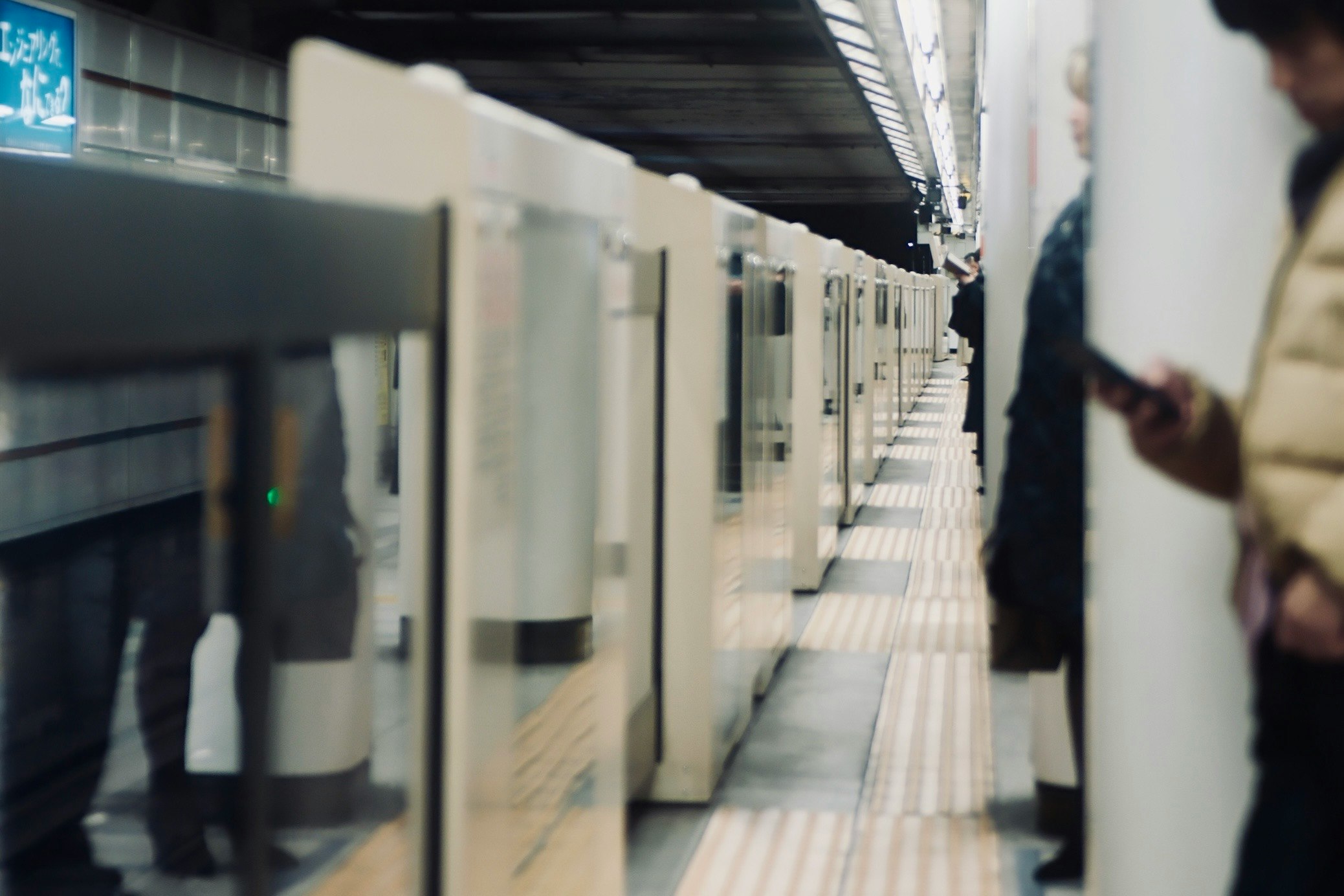side profile of a person in a hallway lined with office cubicles