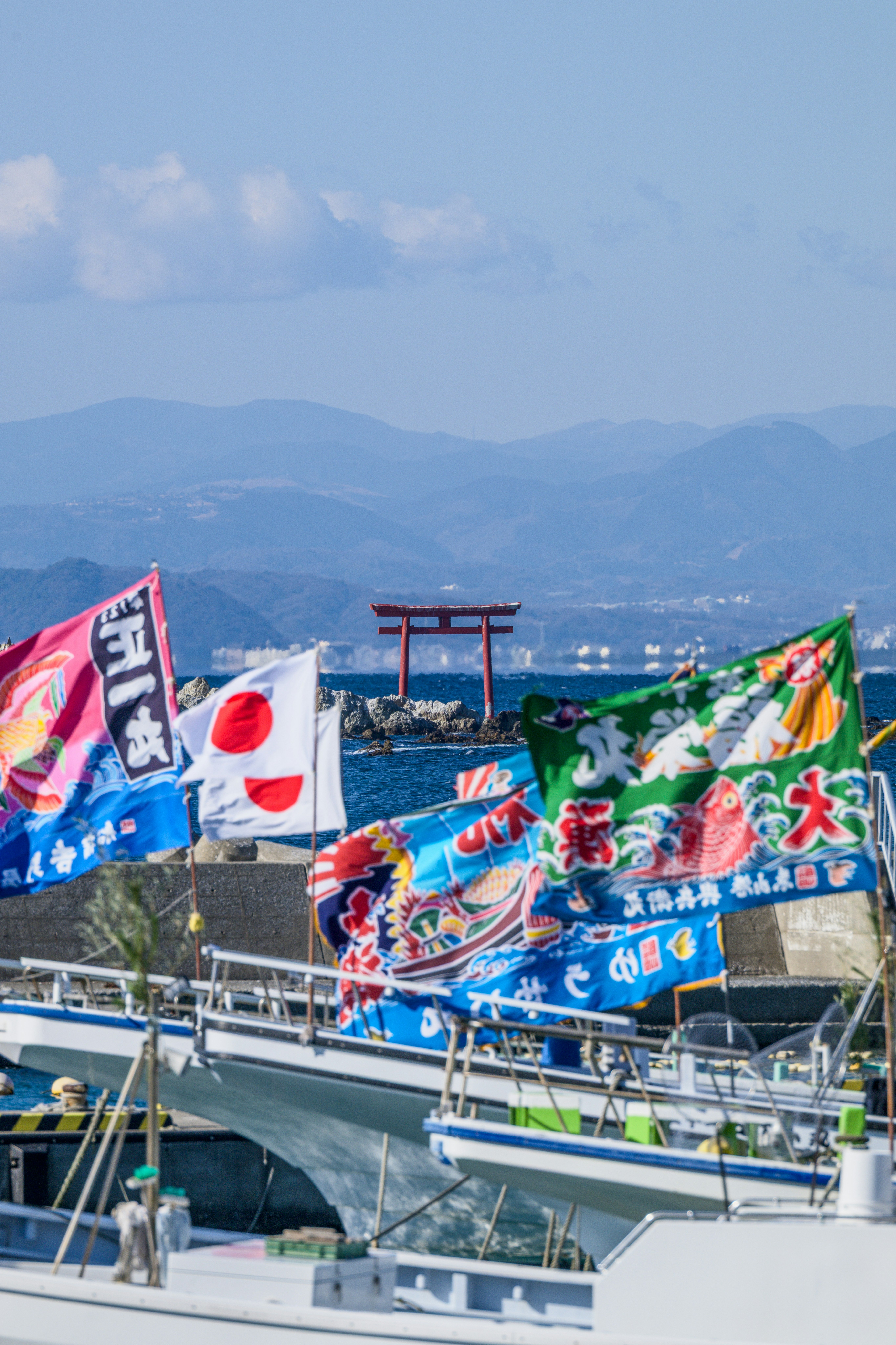 大漁旗と海上の鳥居が見えるお正月の風景