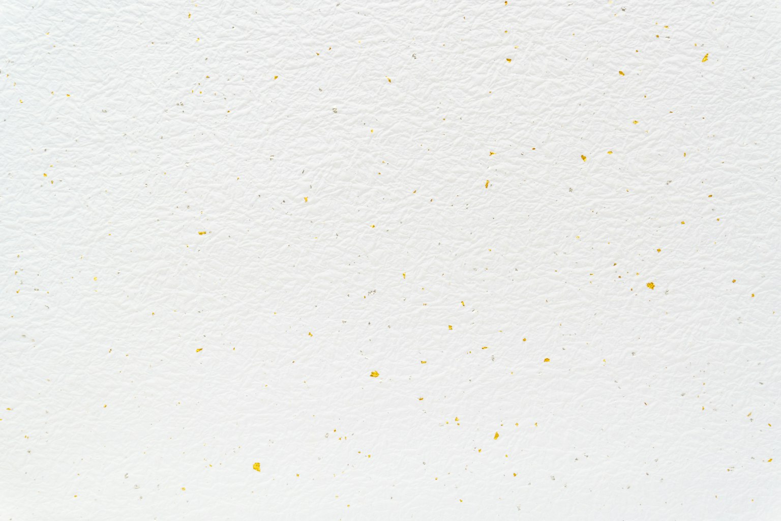 White textured background with scattered small yellow dots