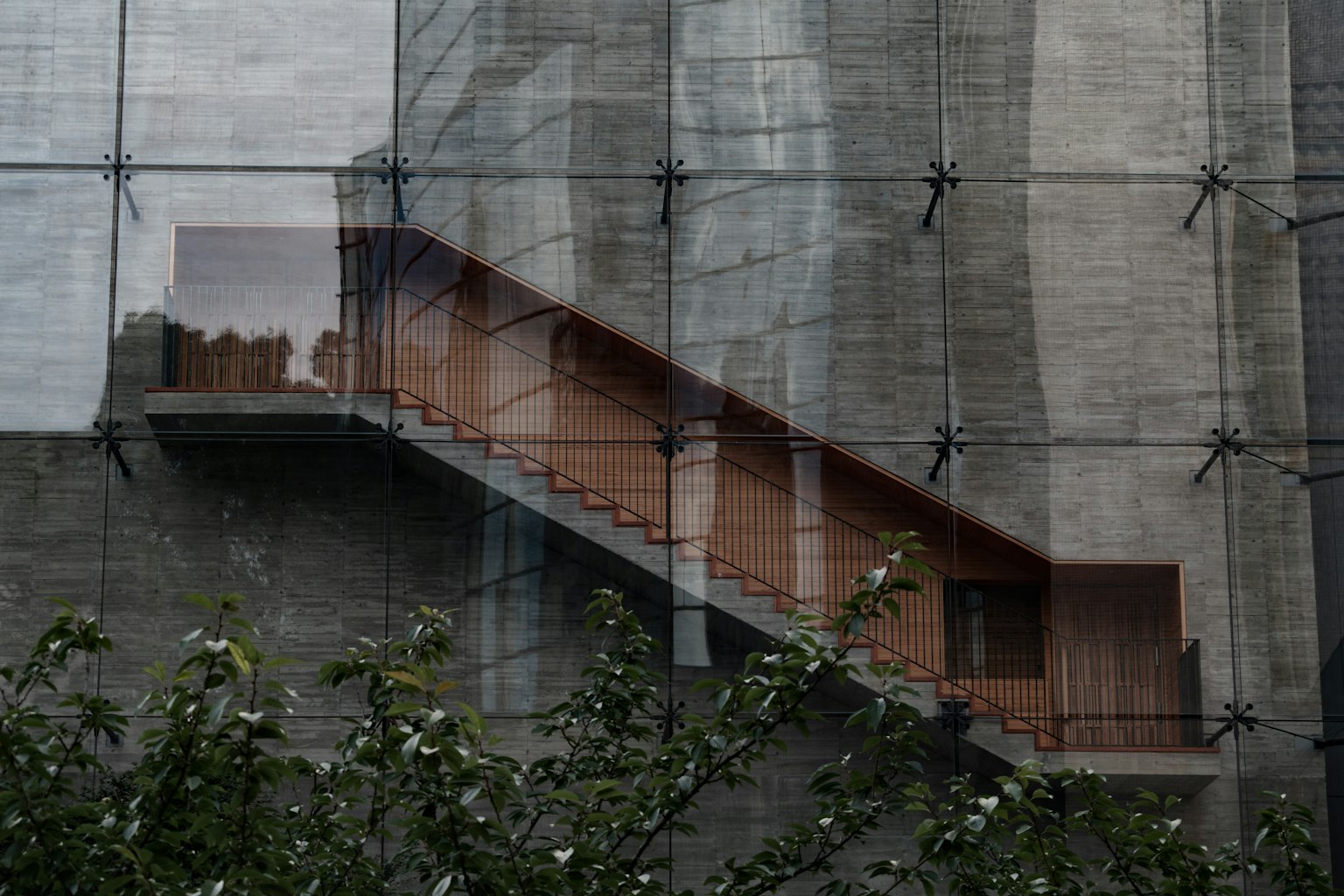 Bild mit einer Holztreppe vor einer Betonwand