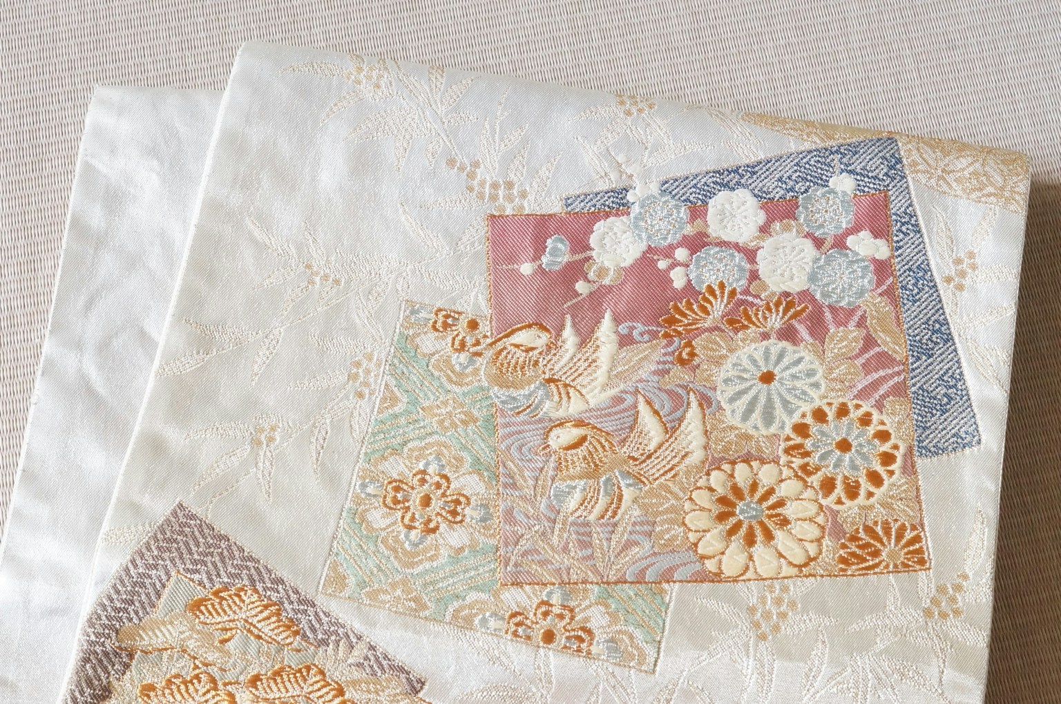 Beautiful patchwork fabric with delicate embroidery in soft colors