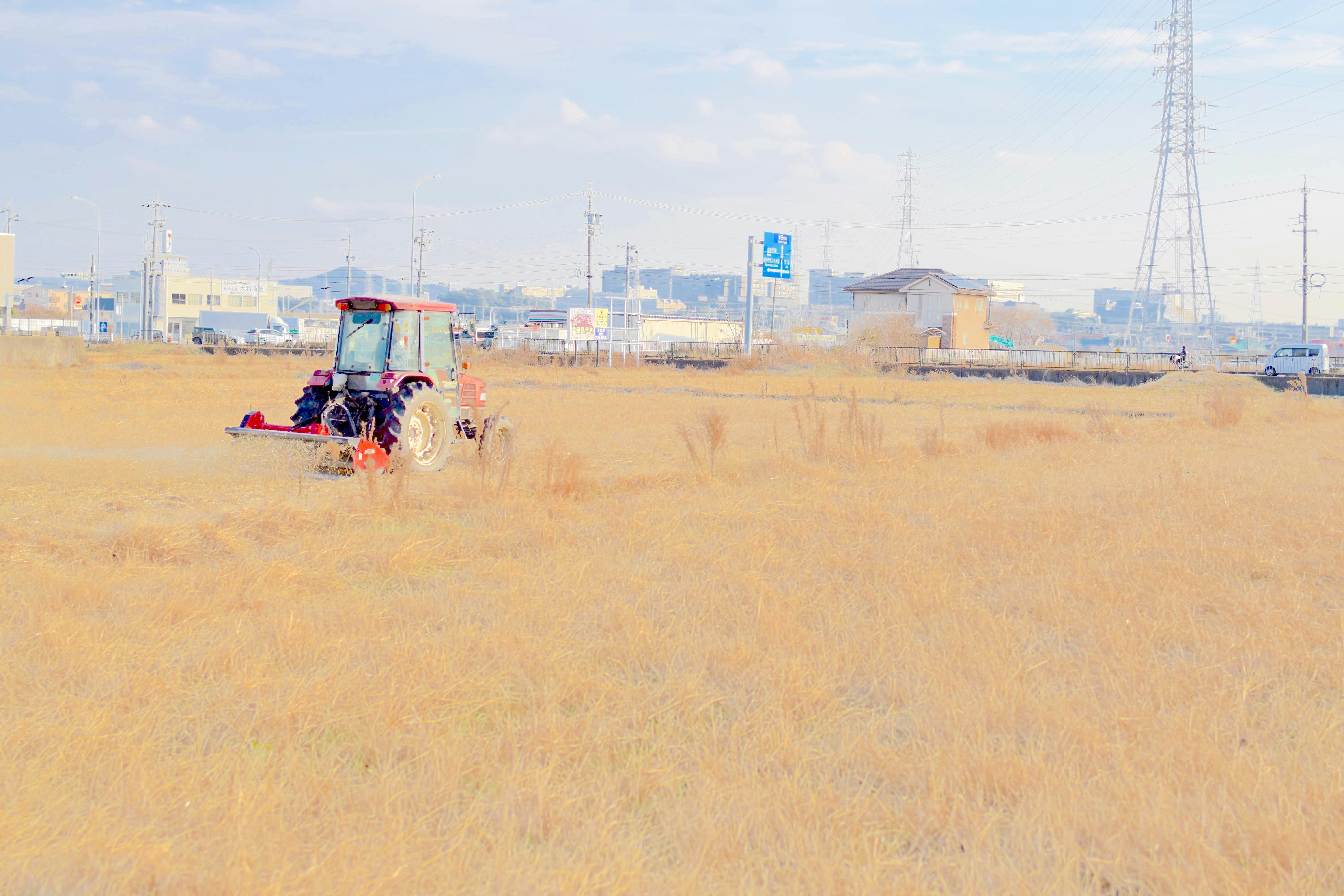 広い砂地を走る三輪バイクのある郊外の風景