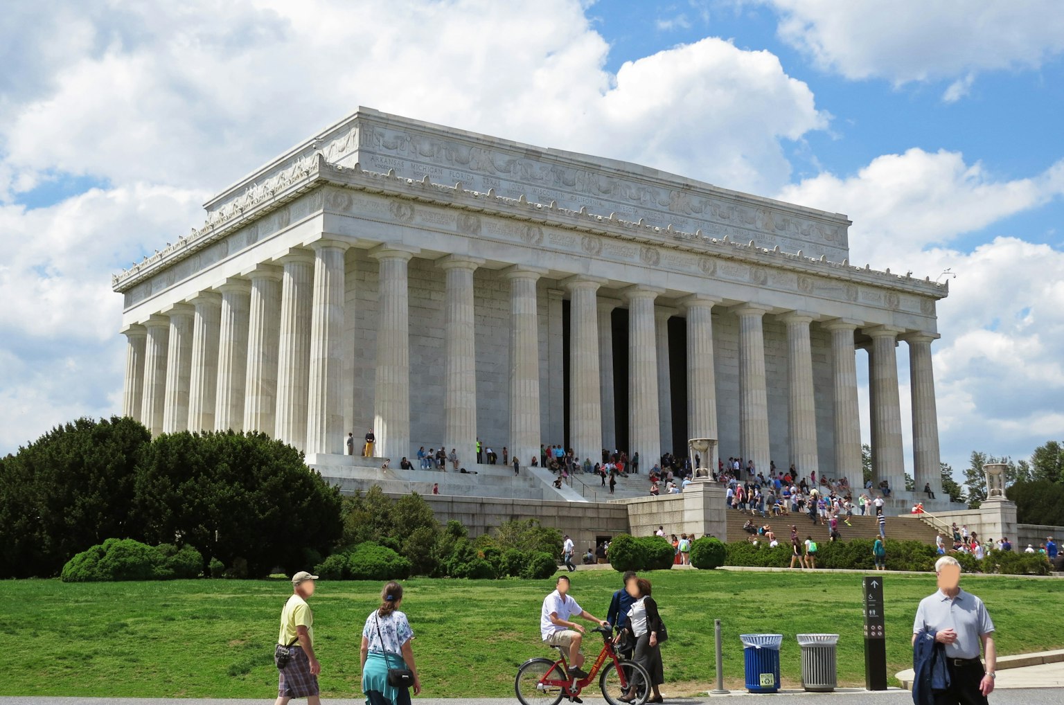 Lincoln Memorial with white marble structure and visitors under blue sky