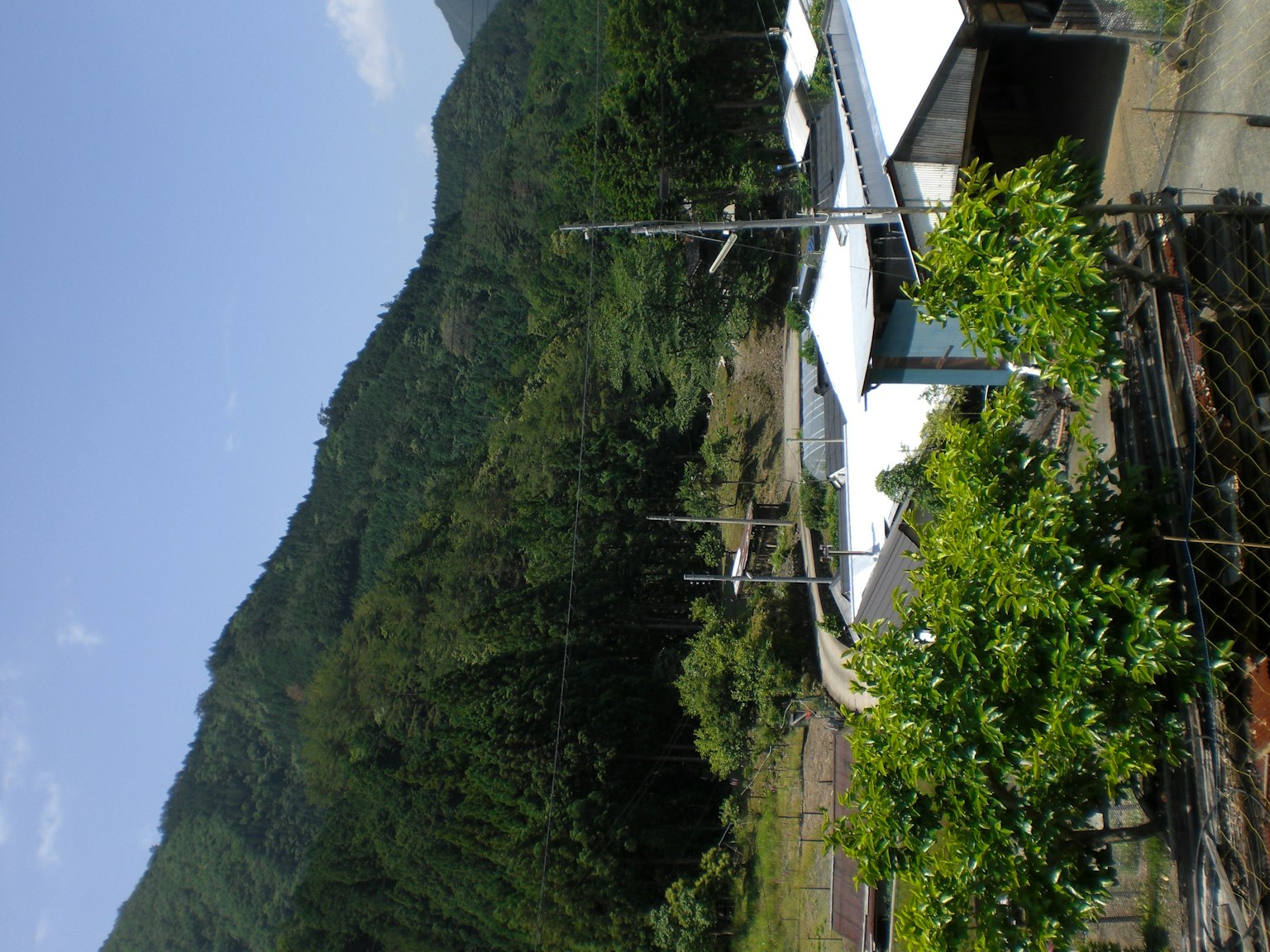Scenic view featuring green mountains and a house with a white roof