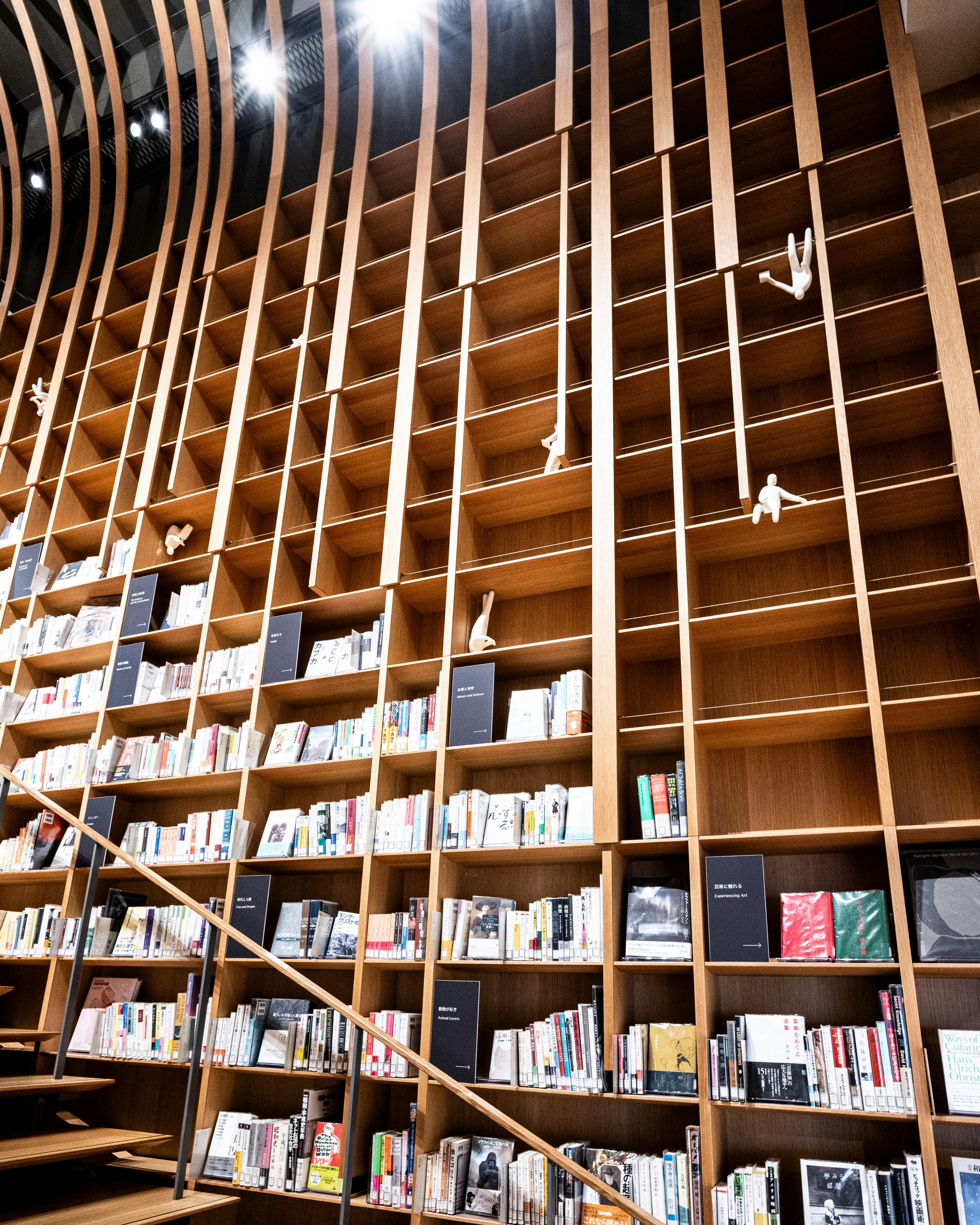 Innenraum einer Bibliothek mit hölzernen Bücherregalen und offenem Atrium