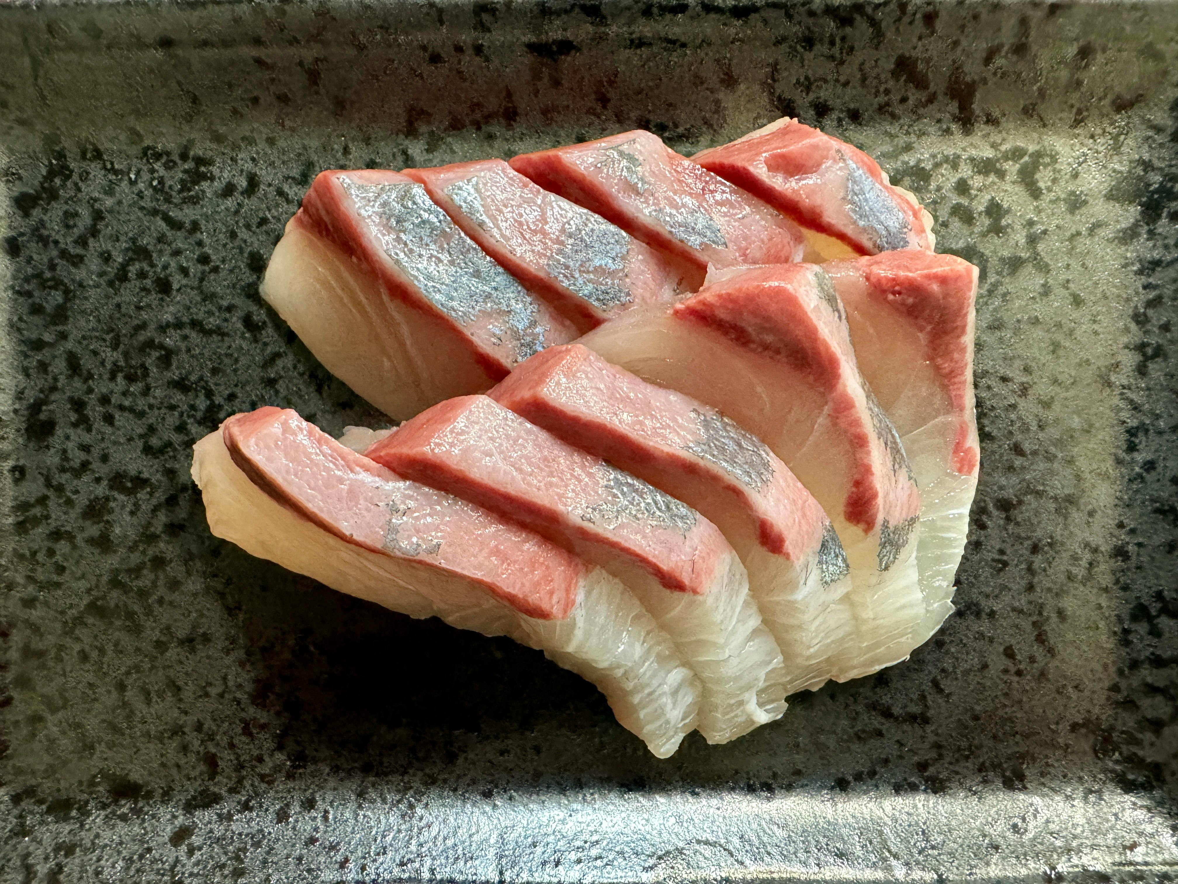 sliced salmon sashimi on a cutting board