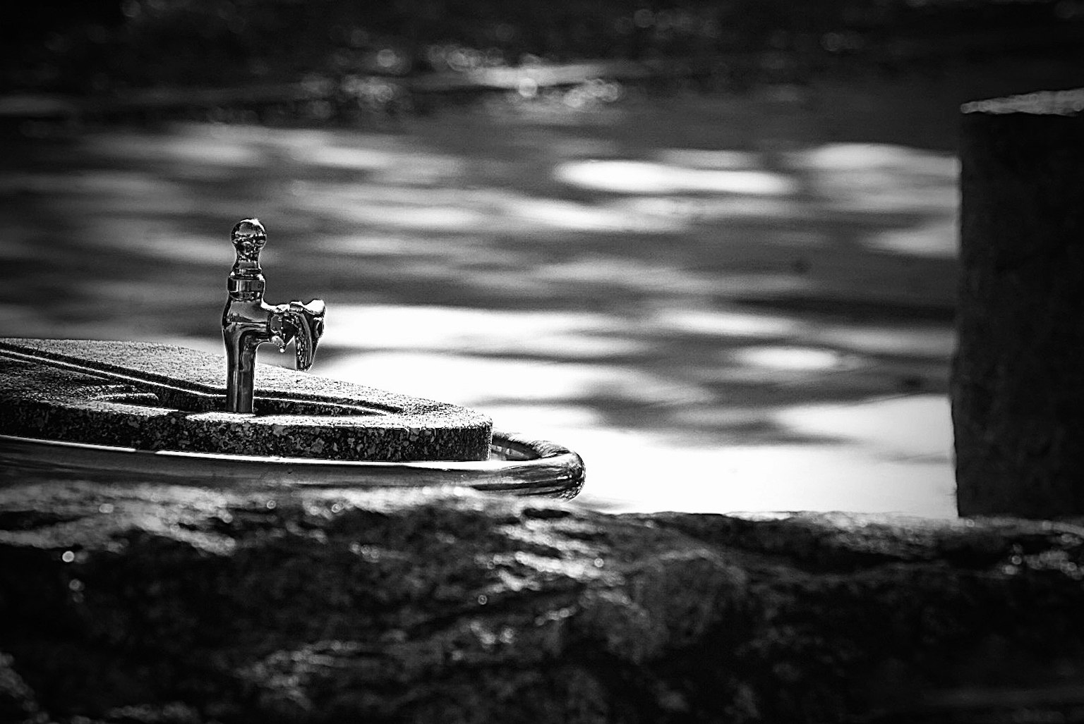 Small boat and calm water surface in a black and white landscape