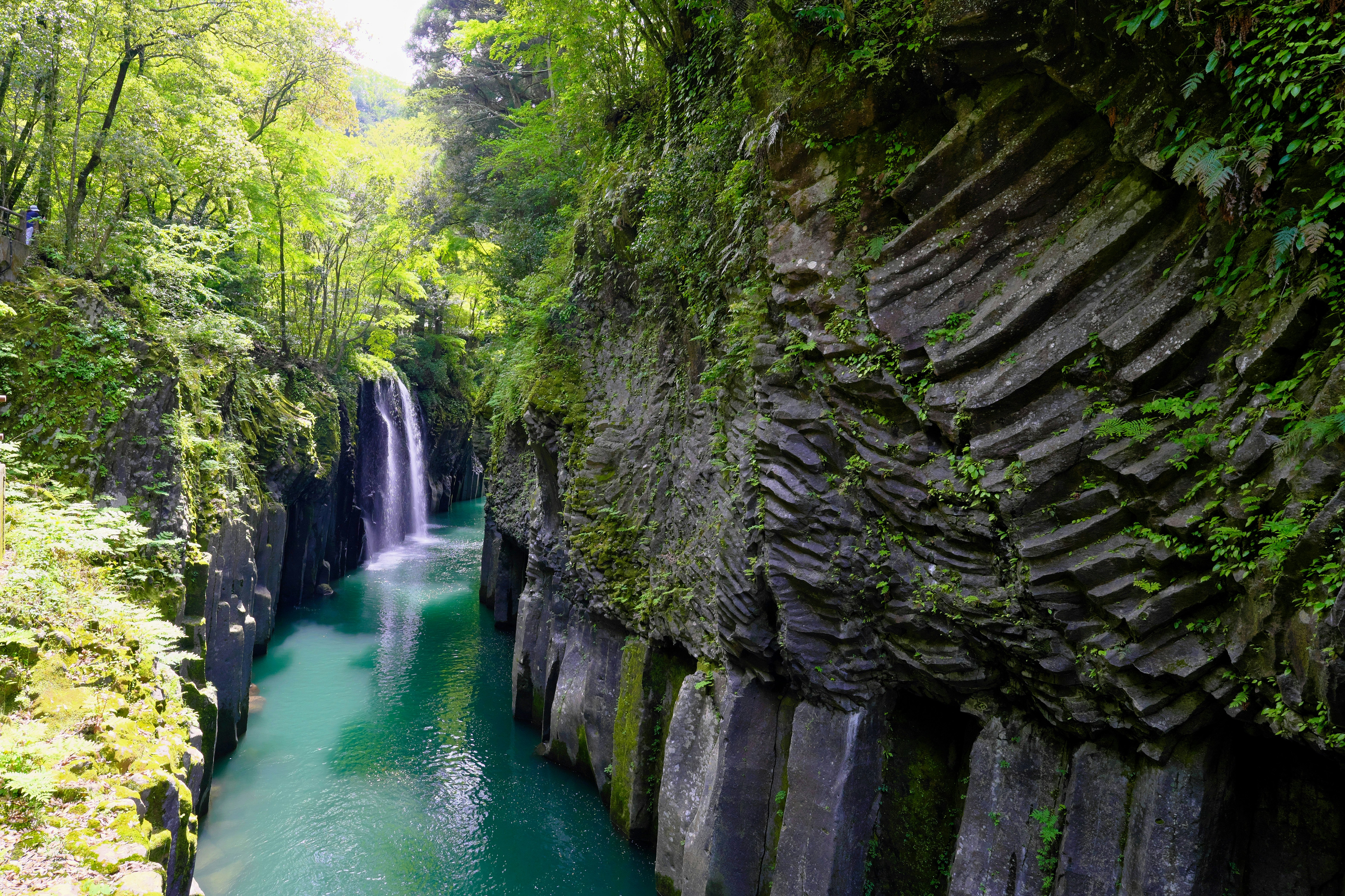 Chutes d’eau le long d’une paroi rocheuse de canyon et rivière émeraude